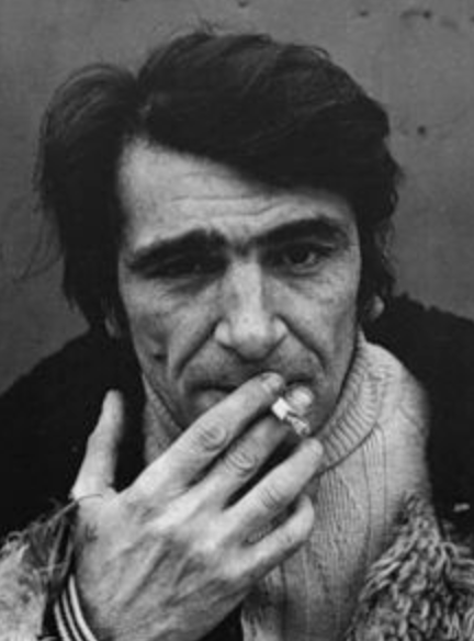 A black and white photograph of the artist Eduard Shteinberg smoking a cigarette