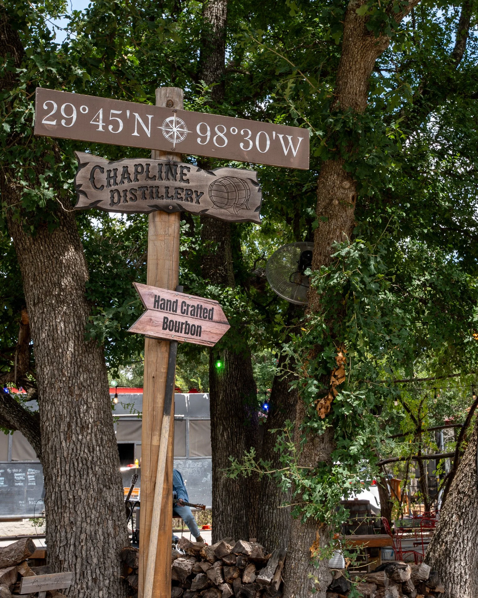 Wood signs with coordinates to Chapline Distillery