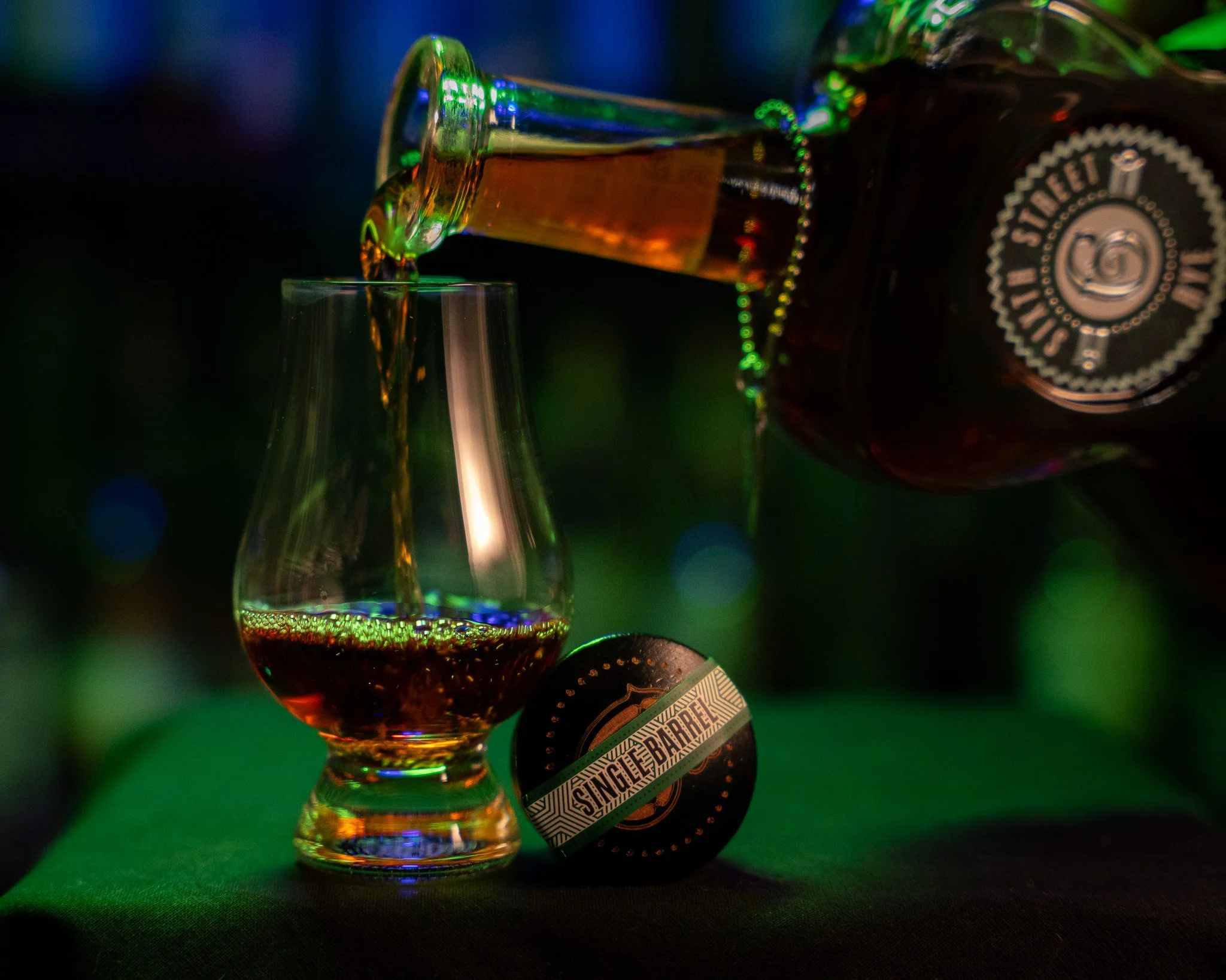 Pouring Sixth Street Rye Single Barrel Barrel Proof into a Glencairn glass.