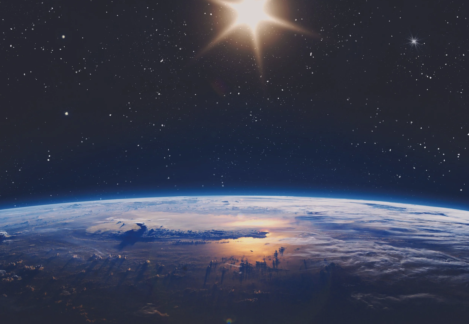 View of Earth from space with the atmosphere glowing at the horizon, above a starry sky with a bright star or planet shining