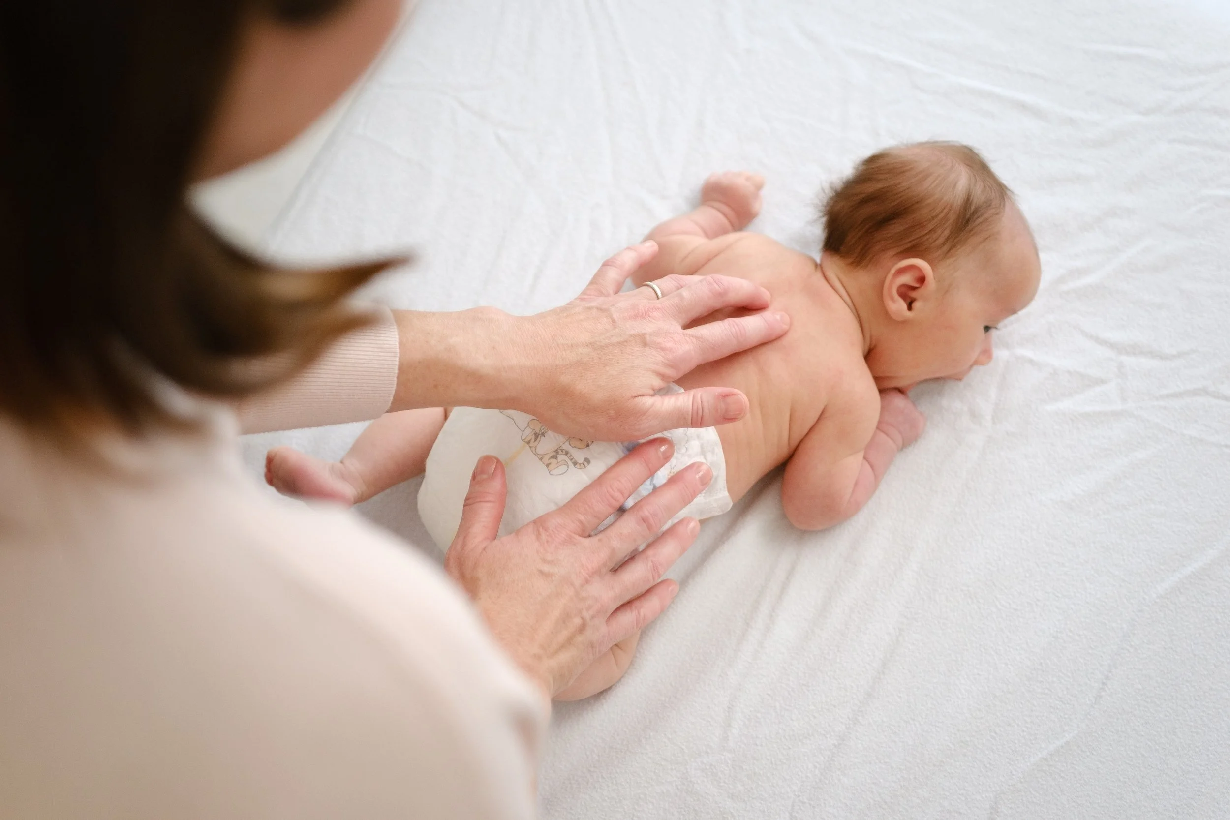 pediatric osteopath working on infant