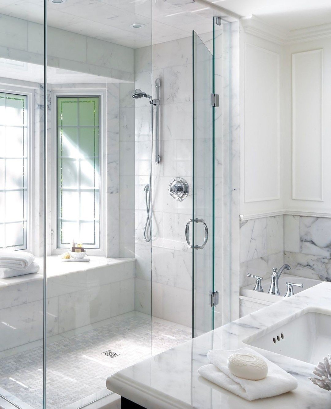 Throwback to an old favourite. We completely reconfigured the second floor of this home and took advantage of an under-utilized space near the bay window.  We turned it into this marble clad principal ensuite, complete with a window bench in the show