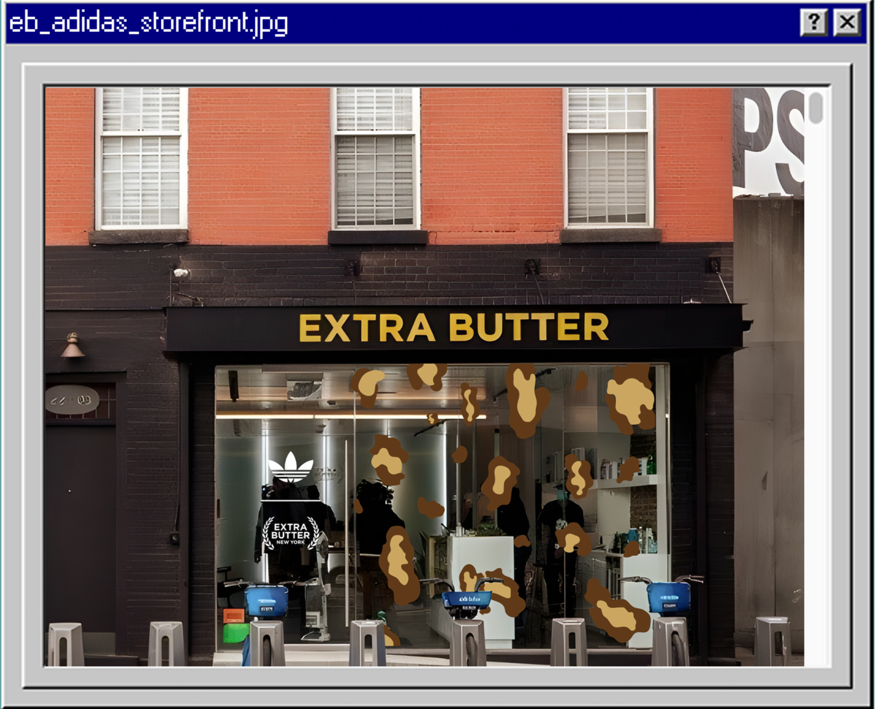 A storefront with a sign that says 'Extra Butter' in yellow letters. The window displays a logo with a white trefoil symbol and the words 'Extra Butter New York.' Brown splatters are visible on the window, and there are several blue electric scooters