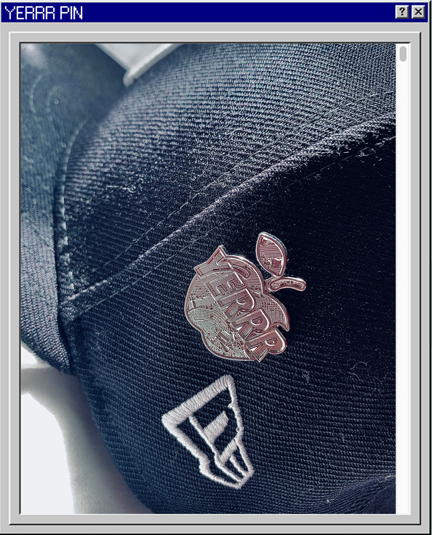 Close-up of a black backpack with a Harley-Davidson pin and a New Era logo patch.