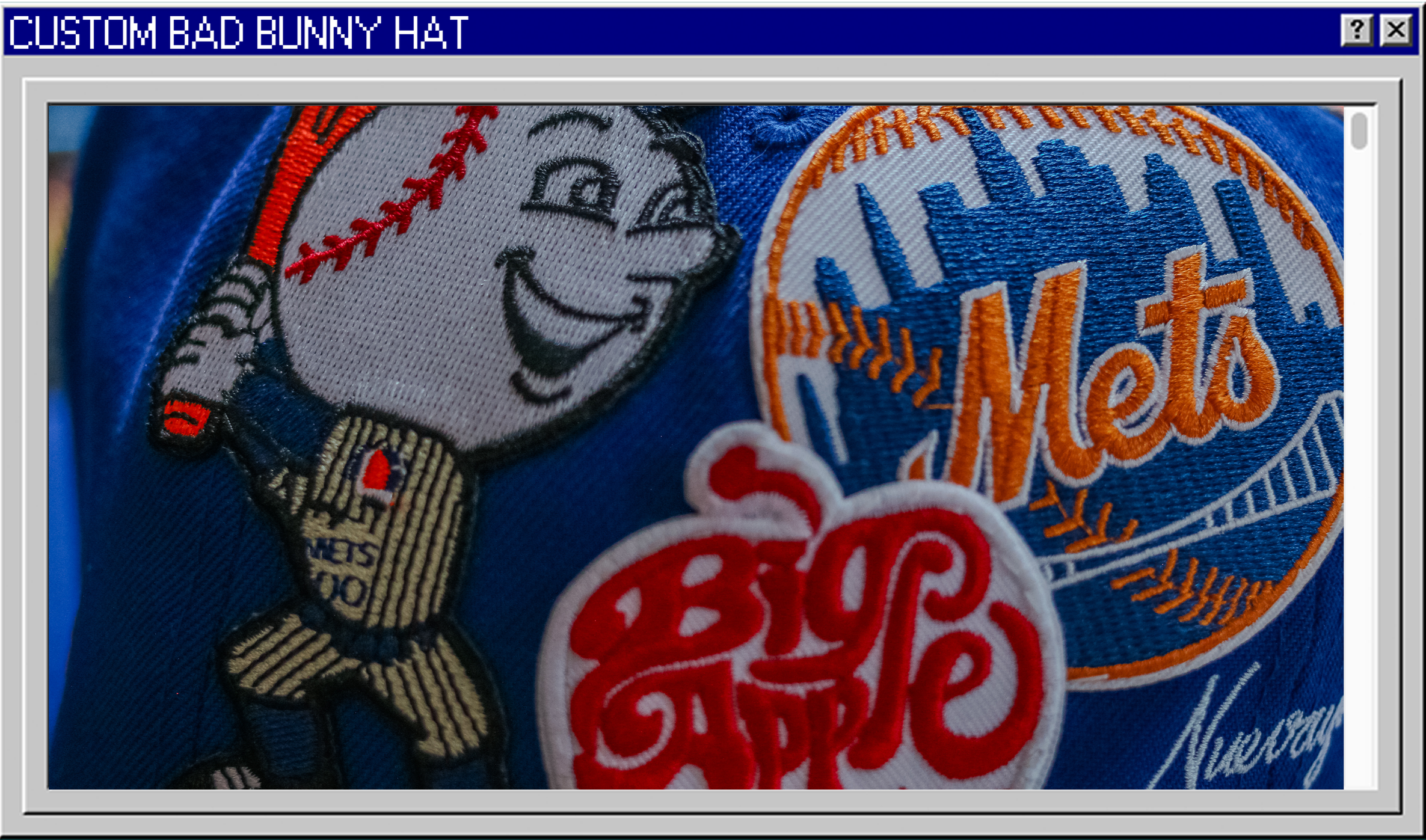 Close-up of embroidered patches on a blue fabric, featuring a smiling baseball with a baseball glove, the New York Mets logo, and a Red Sox logo.
