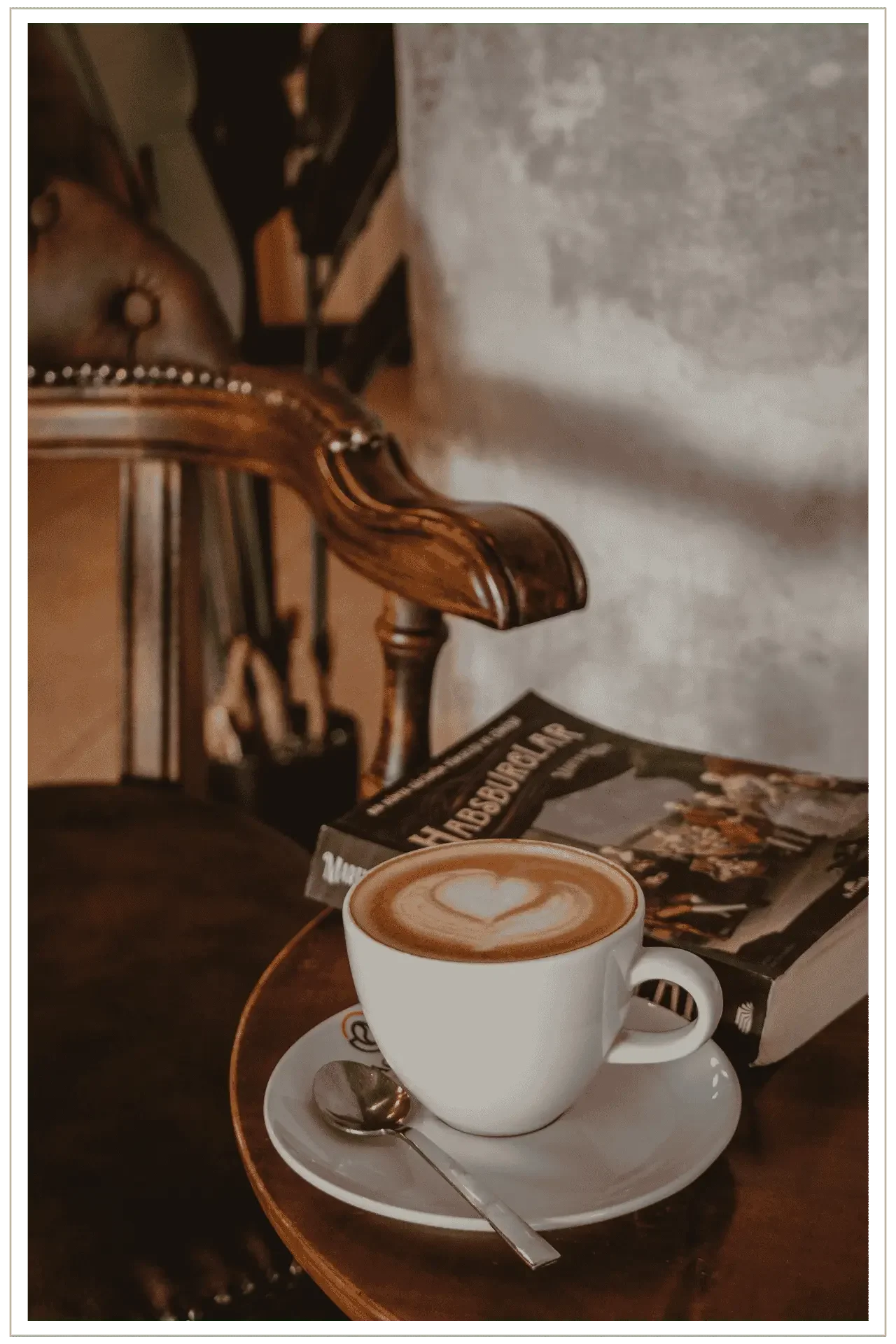 A quiet morning scene with coffee in a character-rich European cafe, accompanied by a book, highlighting the peace of mind and presence provided by dedicated travel advocacy.