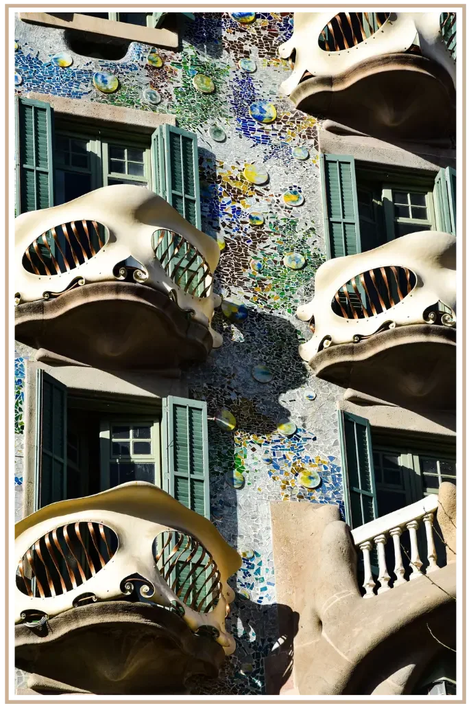 Close-up of the iconic mosaic facade and bone-like balcony railings of Casa Batlló designed by Antoni Gaudí in Barcelona, Spain. Custom Spain vacation planning for US travelers by SC-based travel designer Denise at Mindset Travel.