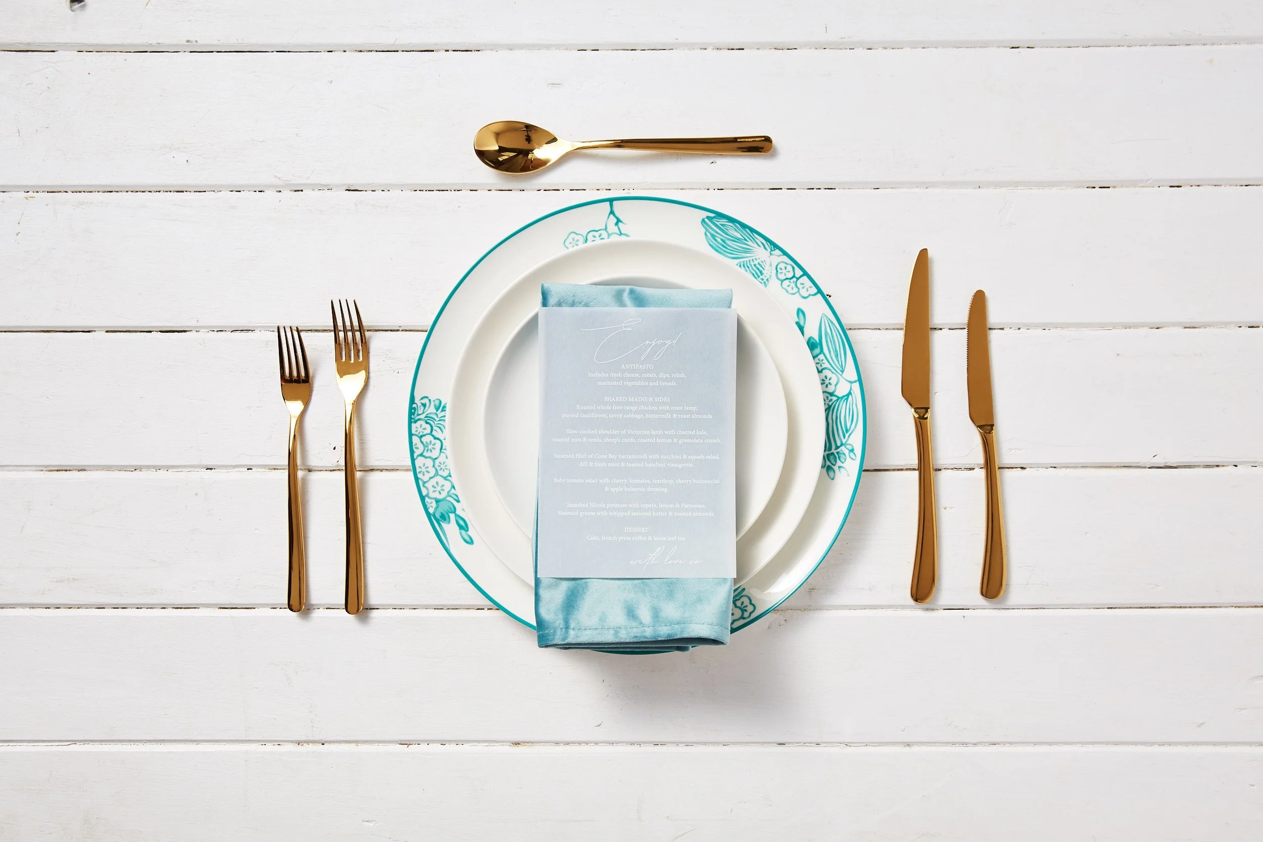 classic gold cutlery with blue and white charger plates