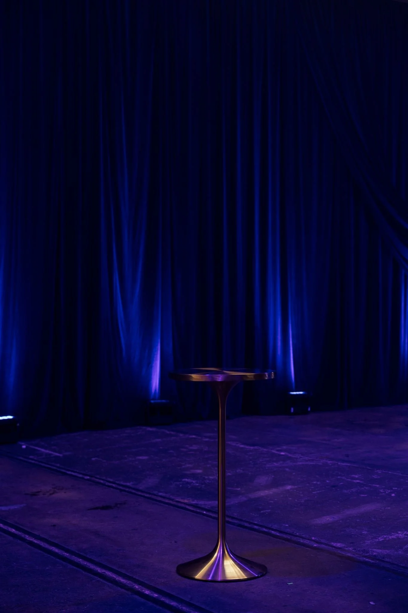 This hourglass-shaped bar table, crafted from a single piece of brushed brass, exudes refined sophistication and a striking presence in any setting.