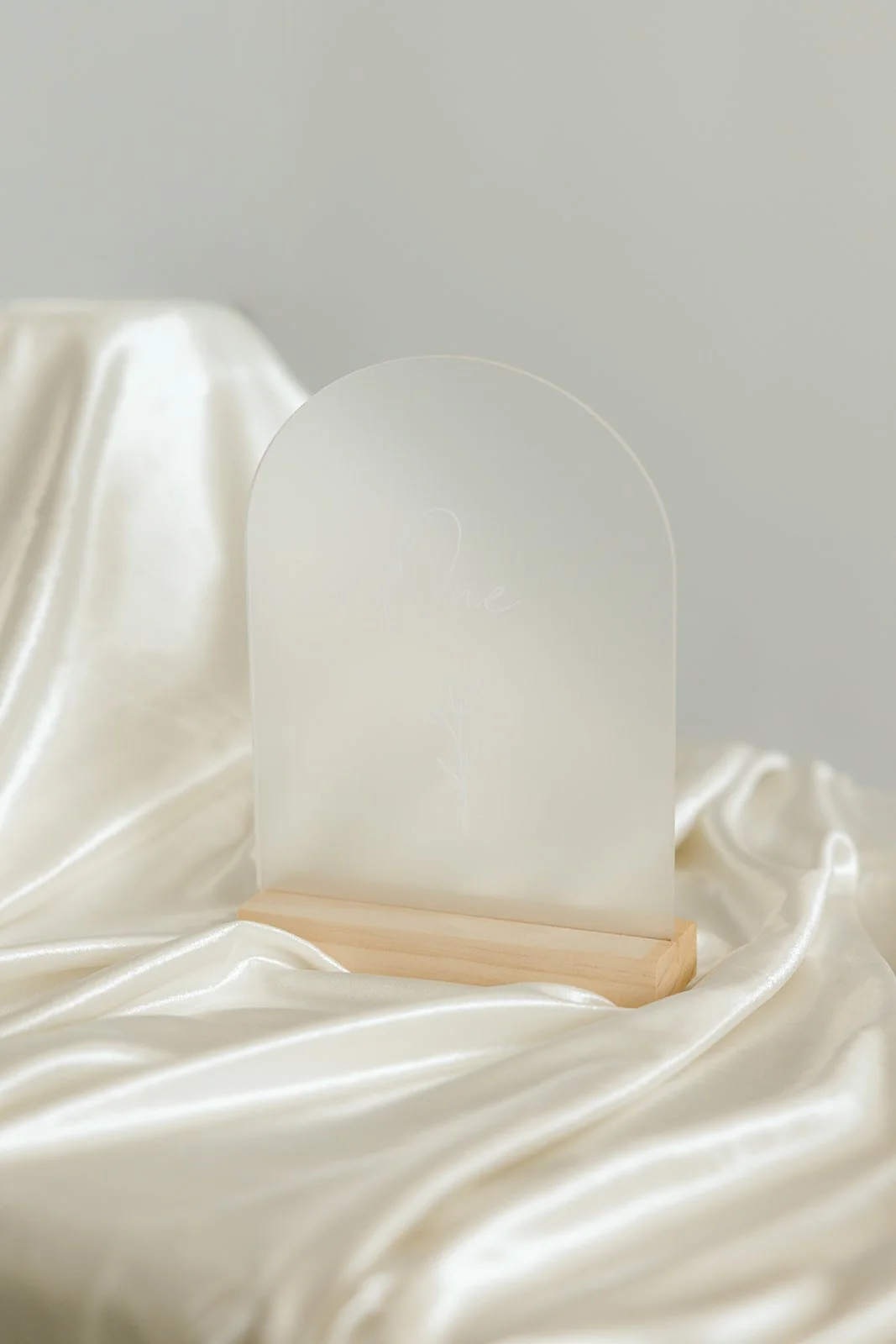 Clear frosted table numbers with wooden base