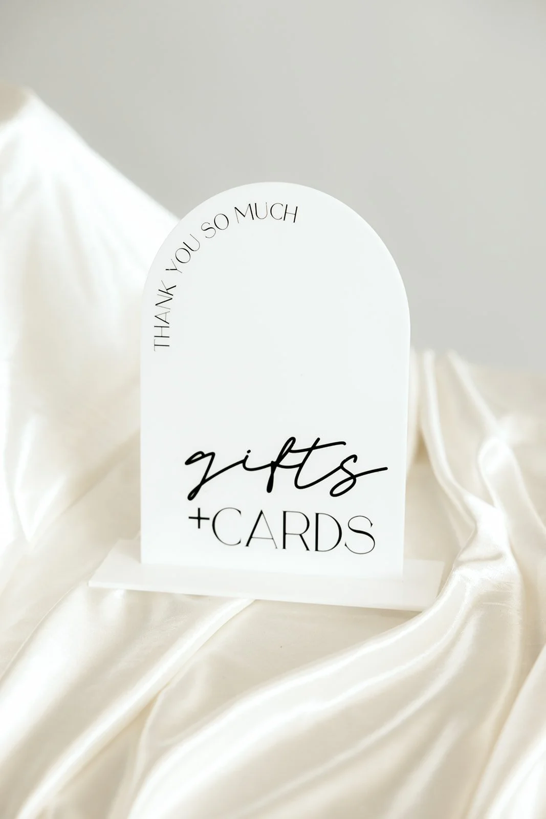 arched white gifts and cards sign