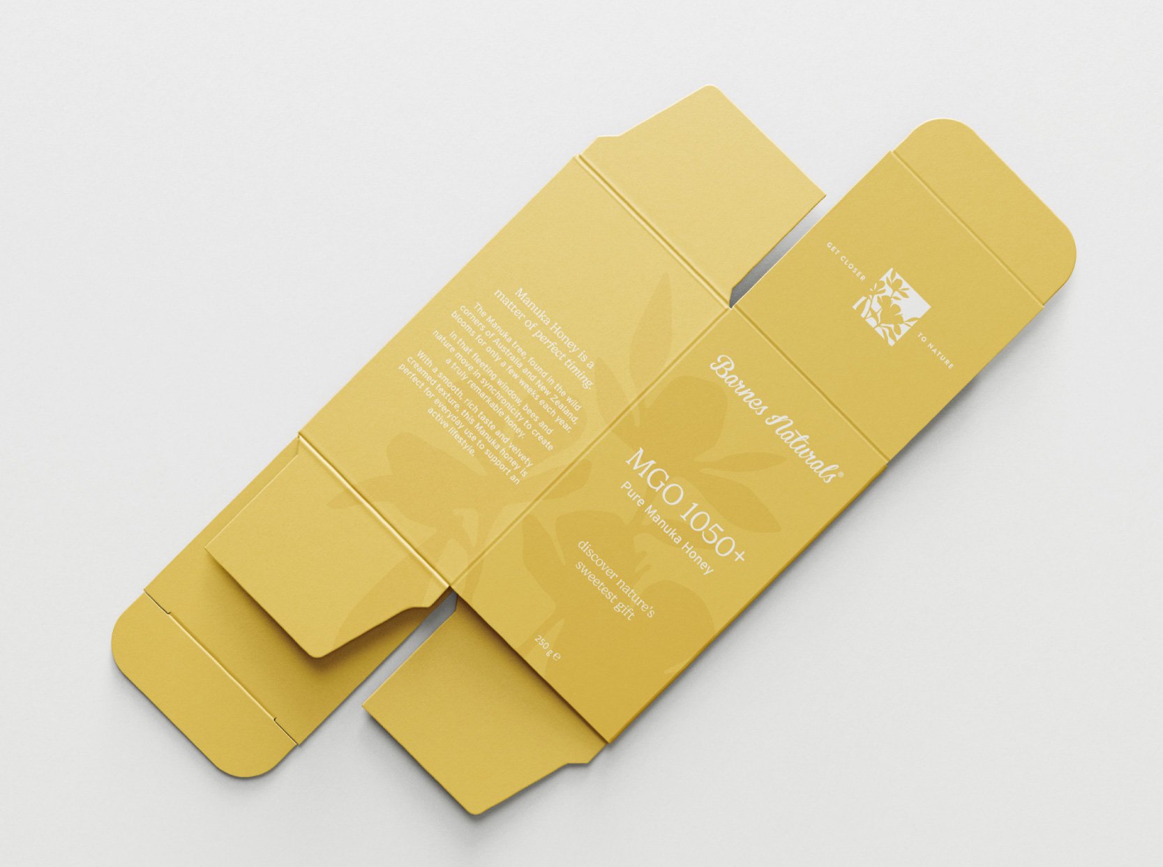 Scenic landscape featuring a turquoise lake surrounded by green and brown rolling hills and towering mountains partially covered with clouds in the background.