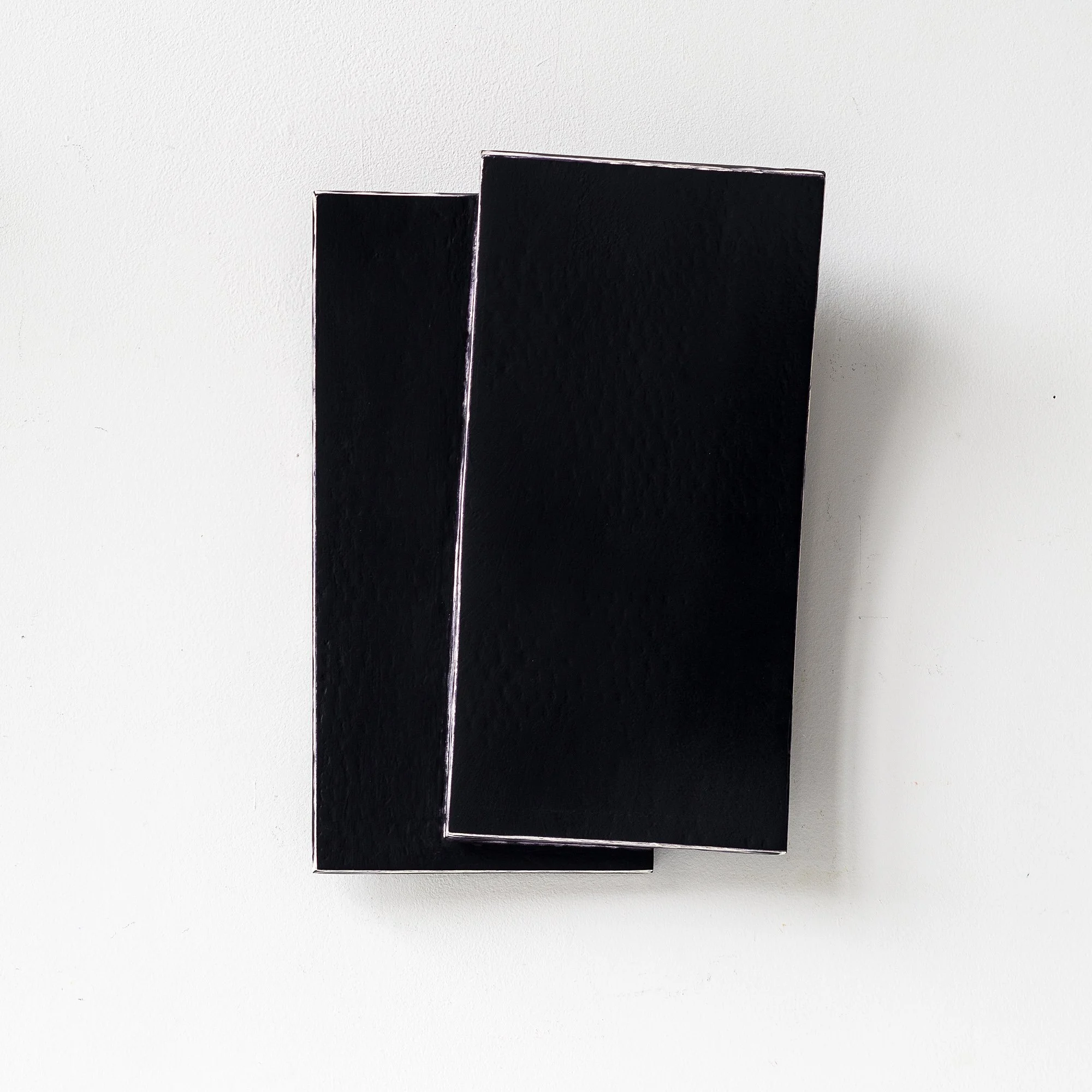 SOLD

Two black rectangular sheets overlapping, placed on a white background.