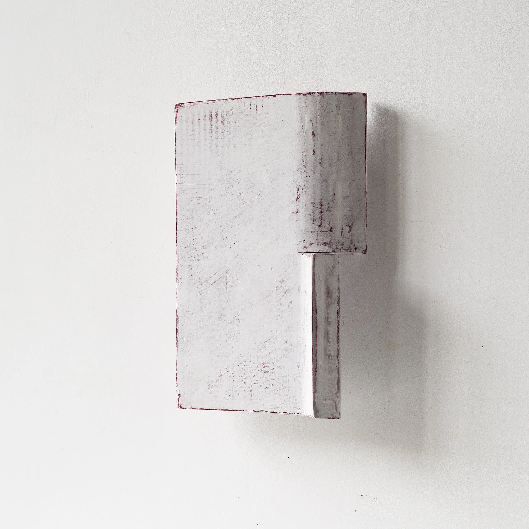 SOLD

Abstract wall sculpture with a white textured surface and angular shapes, mounted on a plain white background.