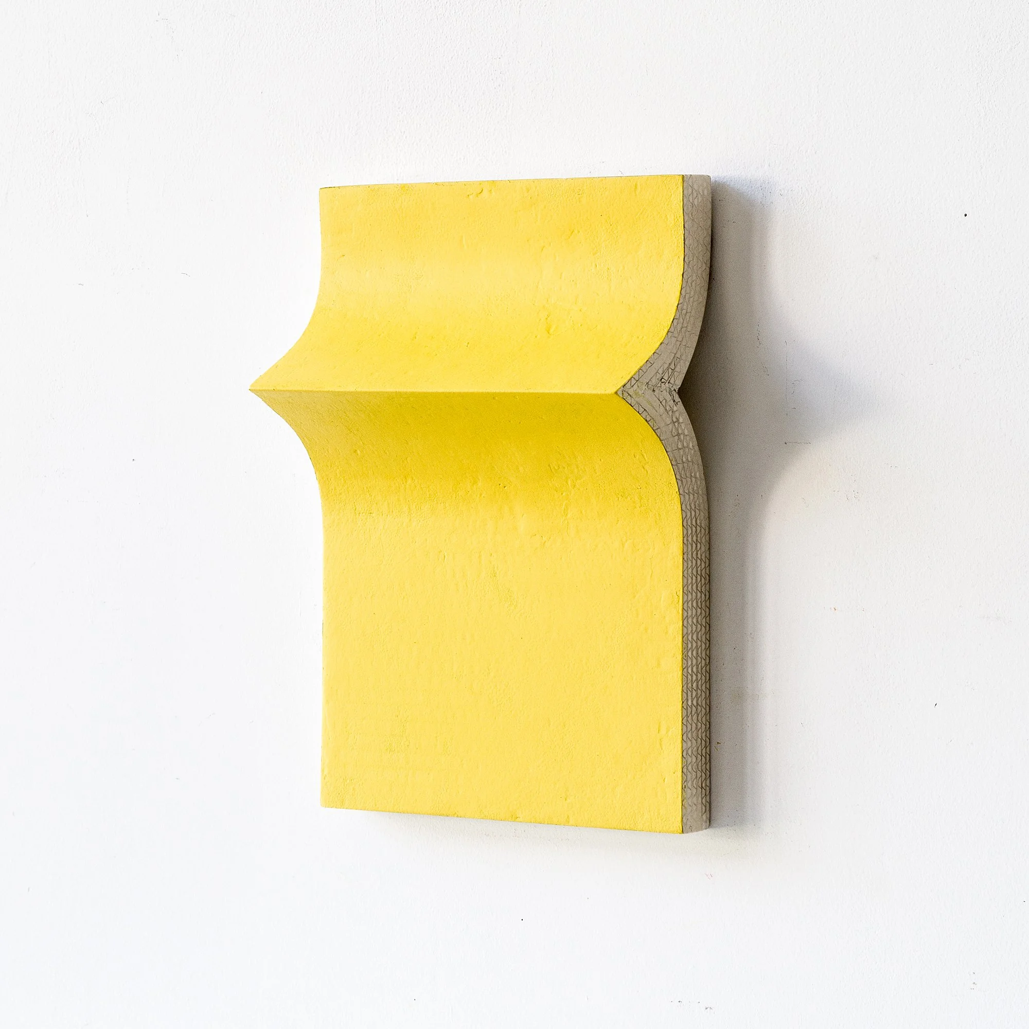 SOLD

A yellow abstract wall sculpture with a curved design against a white background.