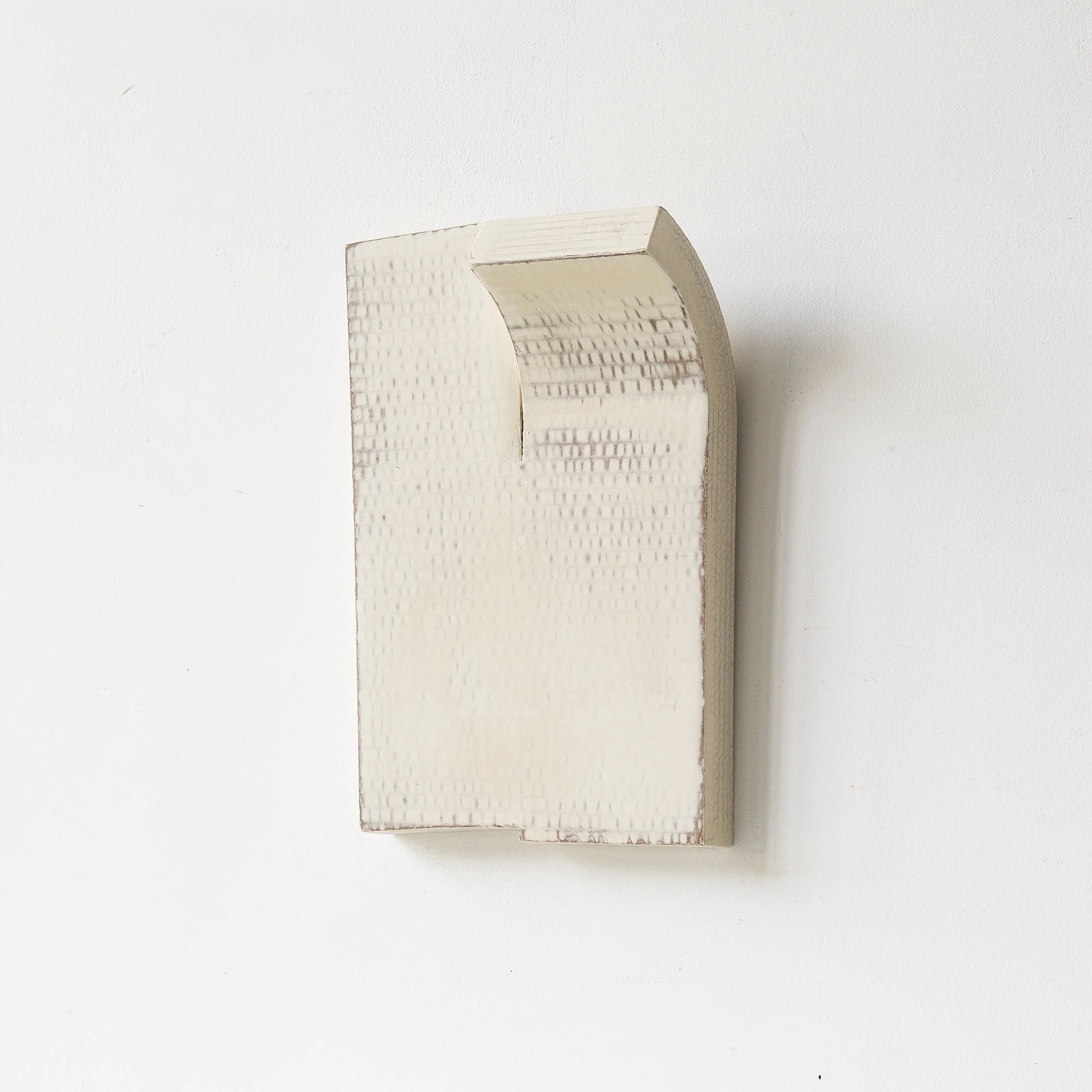 SOLD

This original wall sculpture is handcrafted from cardboard, showcasing a minimalist design with a subtly curved top and grid-like textured surface. Finished in off-white tones, the piece combines raw materiality with architectural form, making 