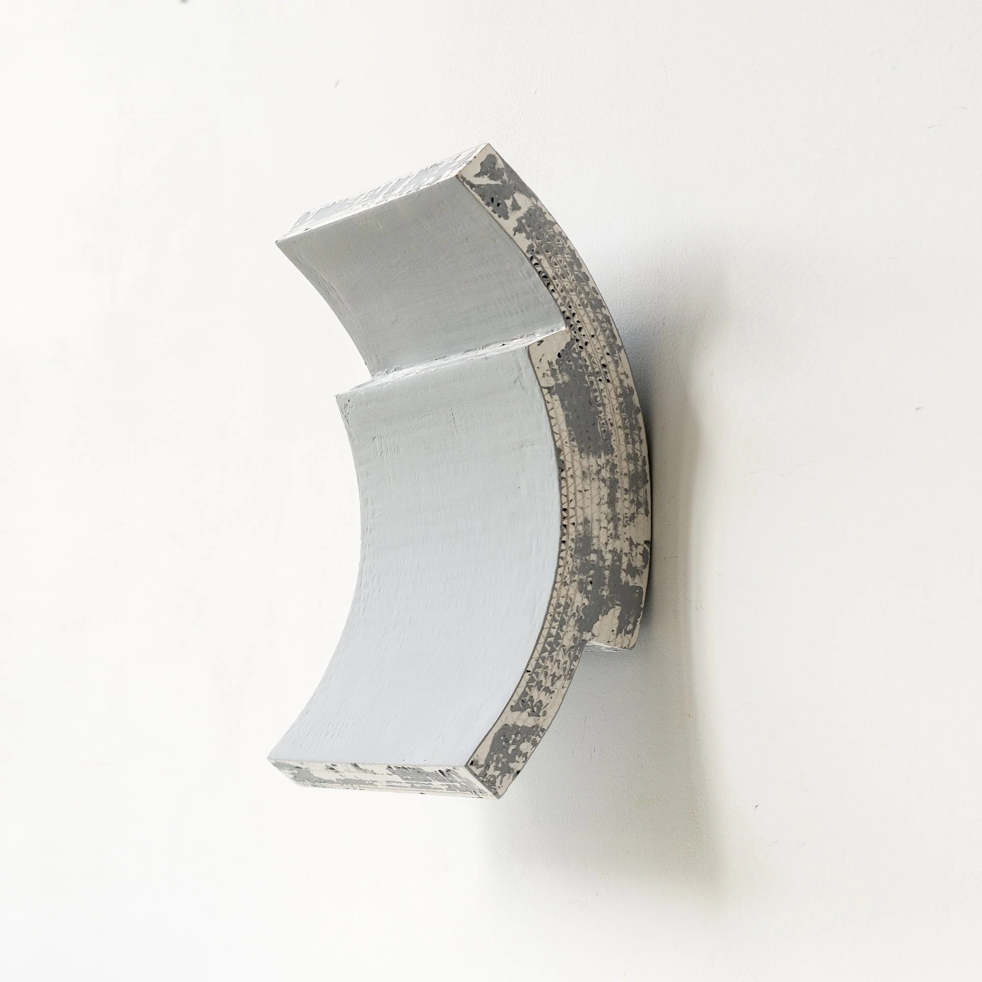 SOLD

Gray, semi-circular minimalist wall sculpture with a textured, aged finish.