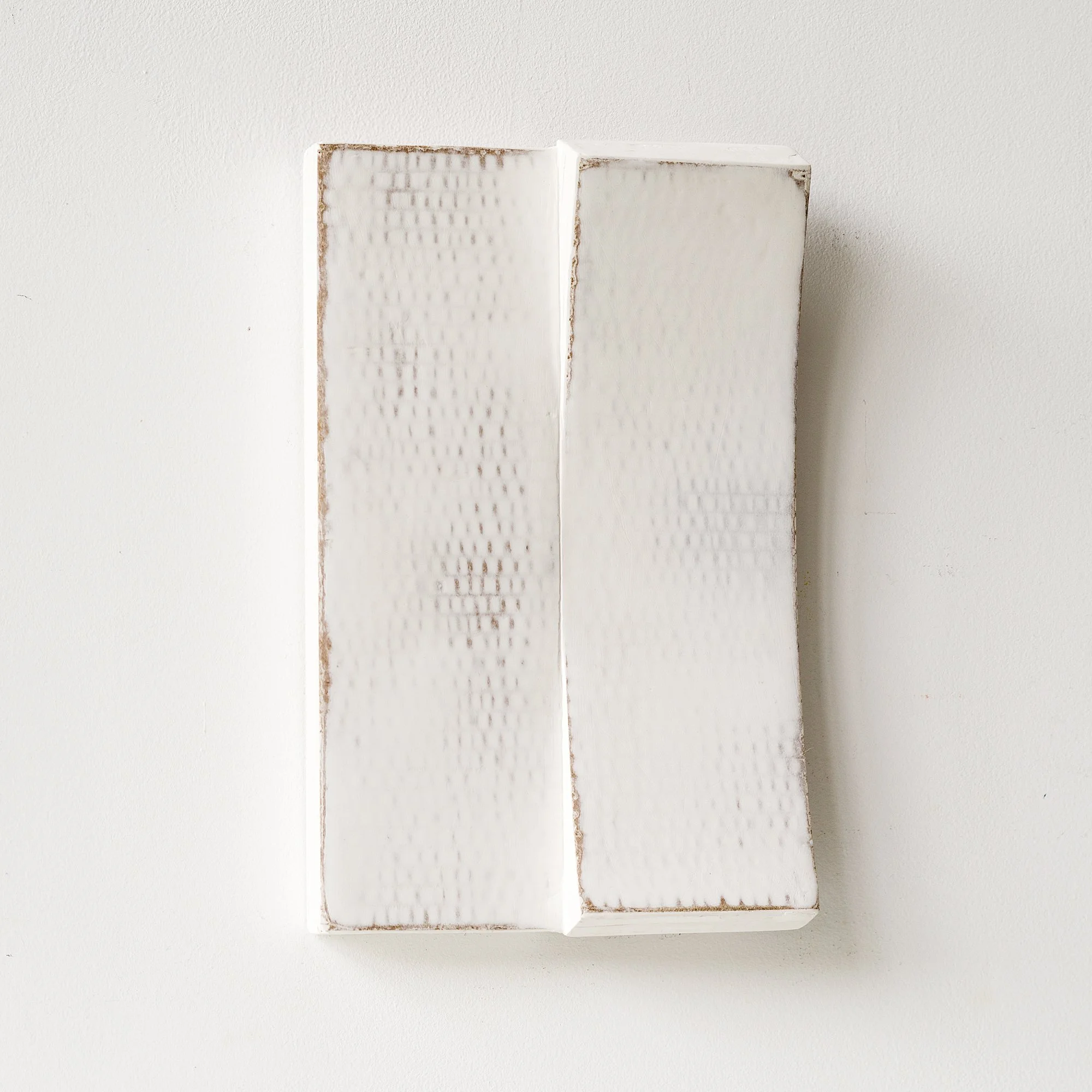 SOLD

White textured ceramic art piece mounted on a white wall