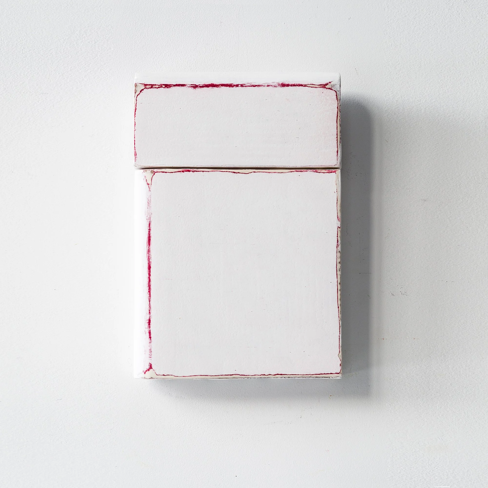 SOLD

Minimalist artwork featuring a white rectangular object with subtle red lines, creating a geometric design against a plain background.