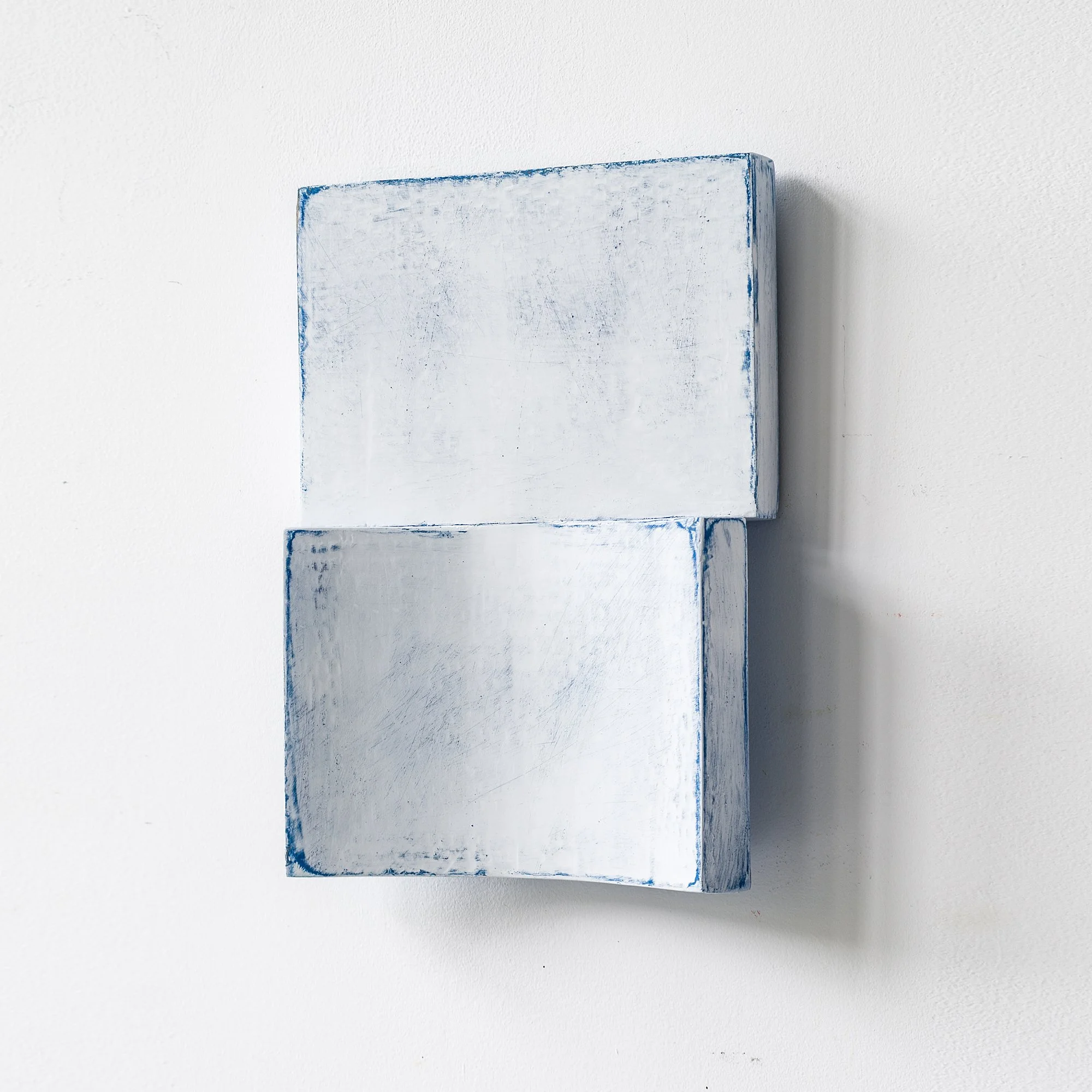SOLD

White rectangular wall sculpture with blue edges, resembling an open book.