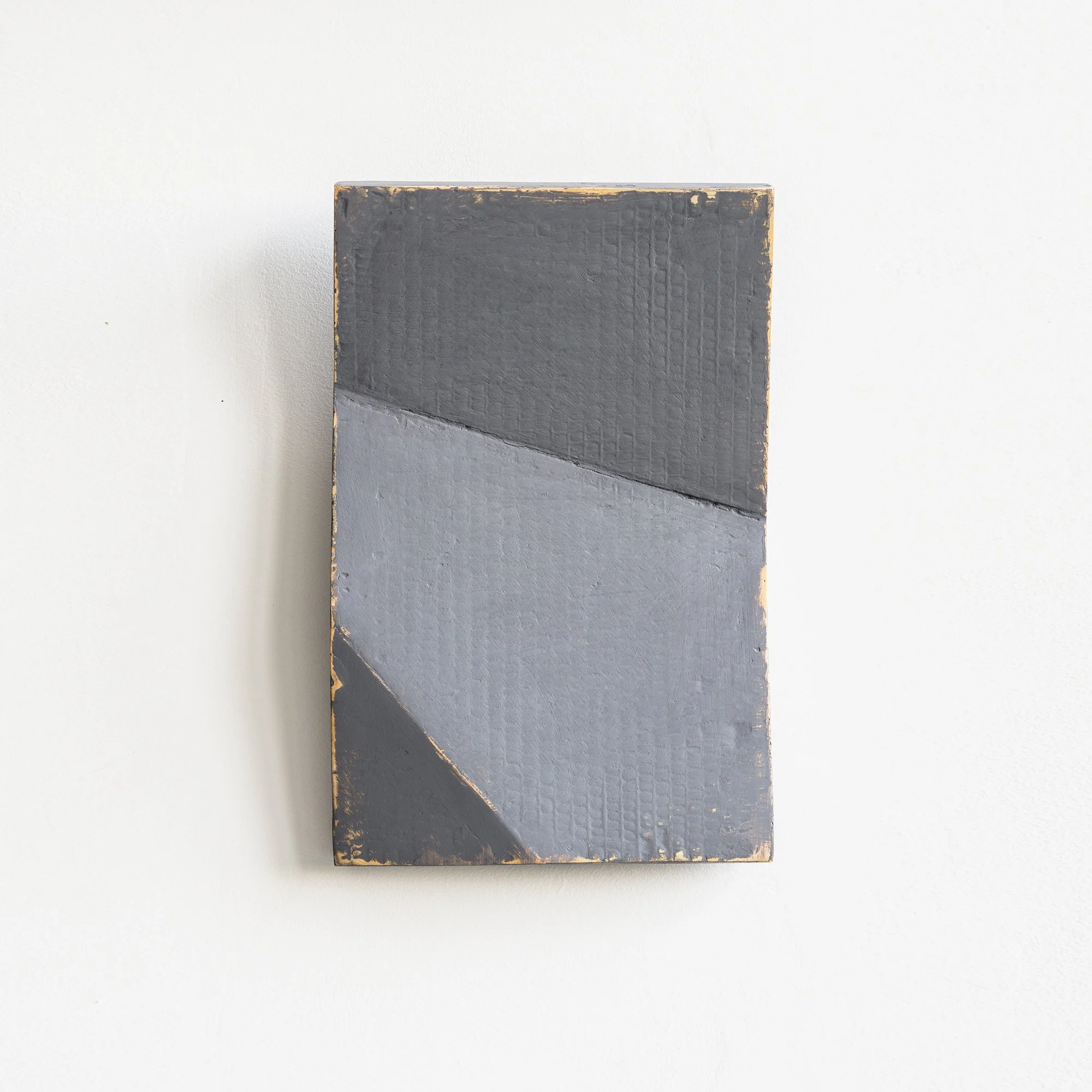 Abstract artwork with intersecting gray and black geometric shapes on a canvas