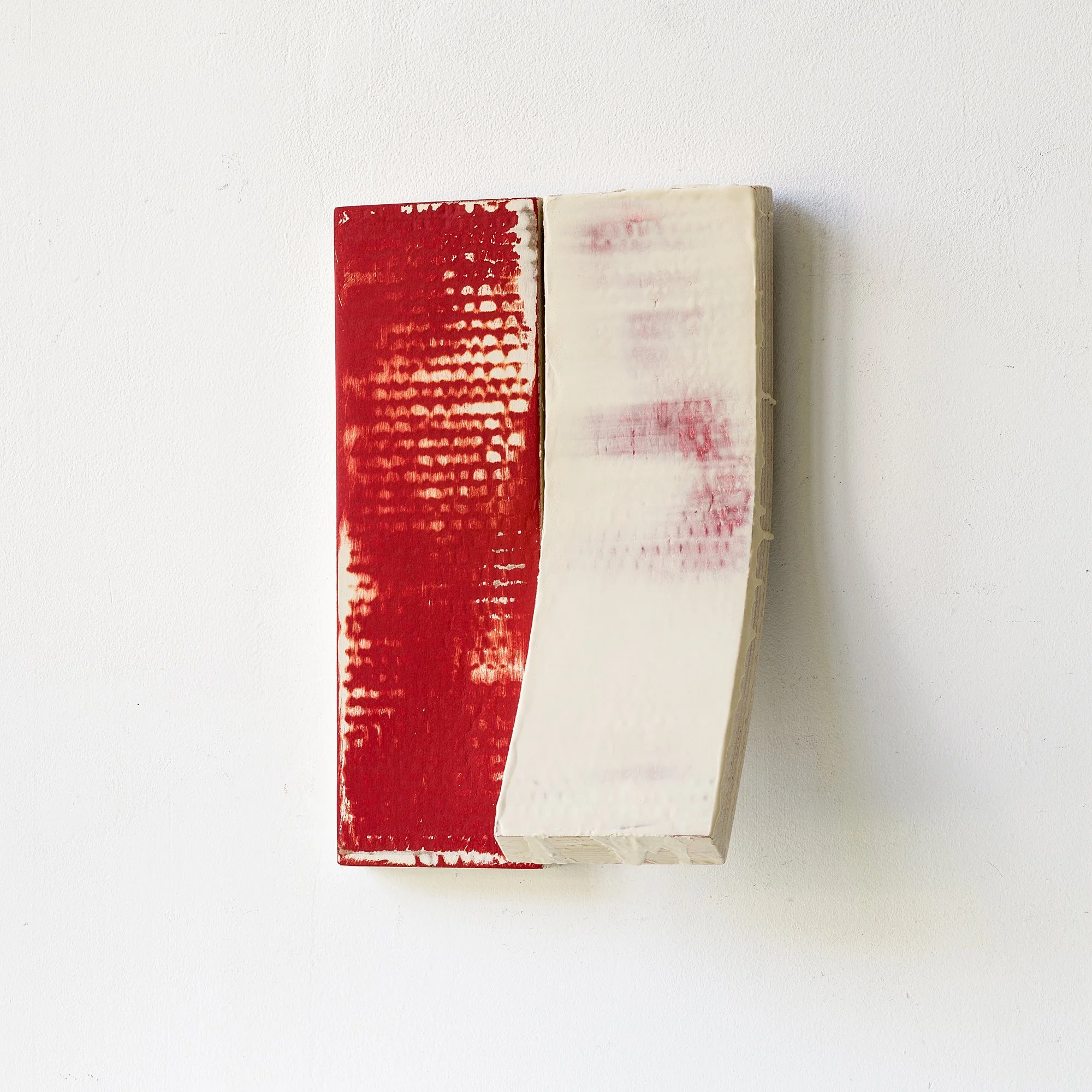 Bring modern elegance and tactile intrigue to your space with this original wall sculpture. This unique piece features two vertically aligned cardboard panels joined together: one painted in deep crimson red with a grid-like texture, the other a scul