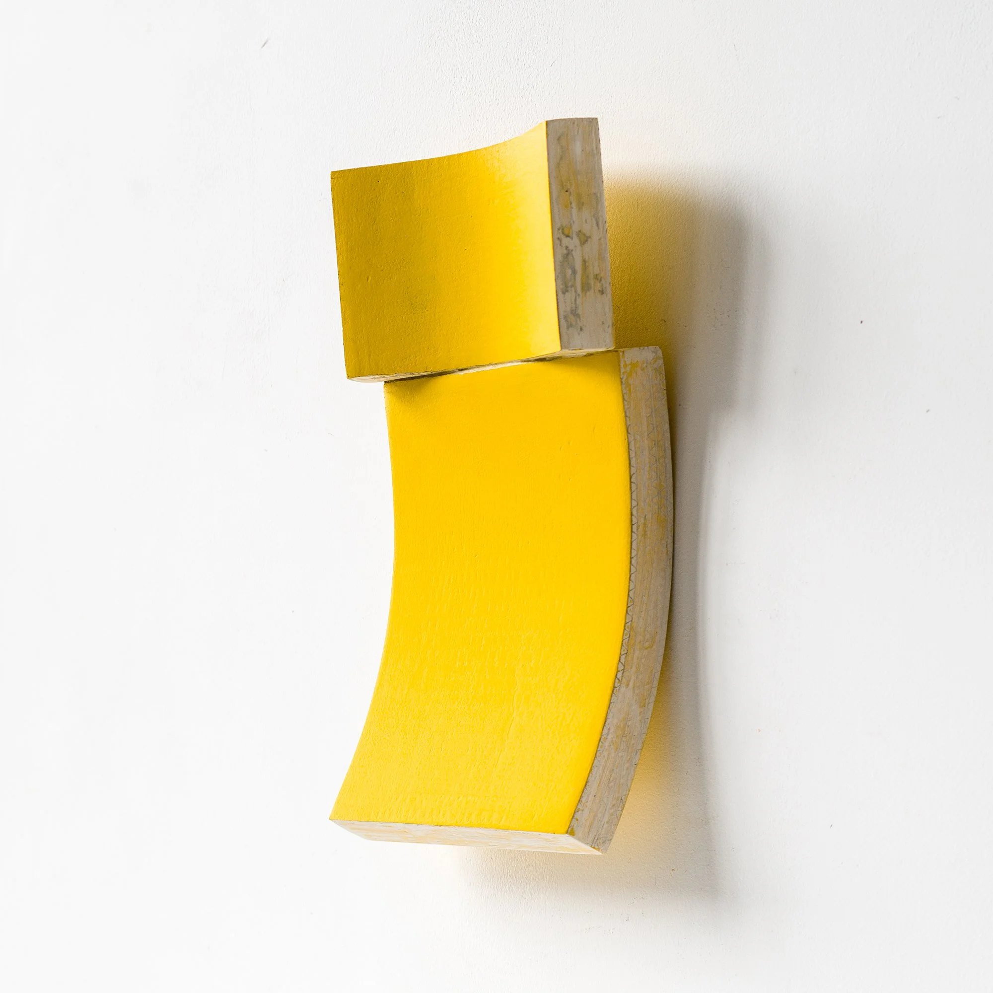 SOLD

A yellow, curved, geometric wall sculpture on a white background.