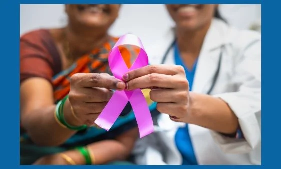 A woman with her doctor, holding together pink ribbon.