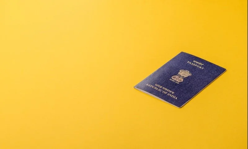 An Indian passport against yellow background.