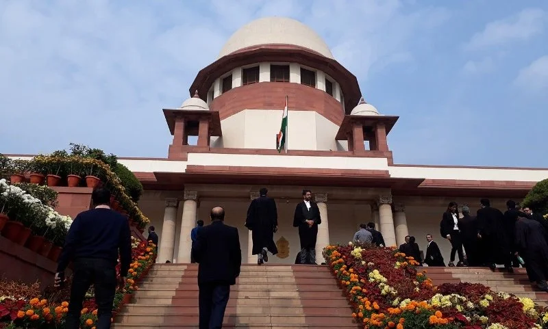 Lawyers climbing stairs at the Supreme Court of India.