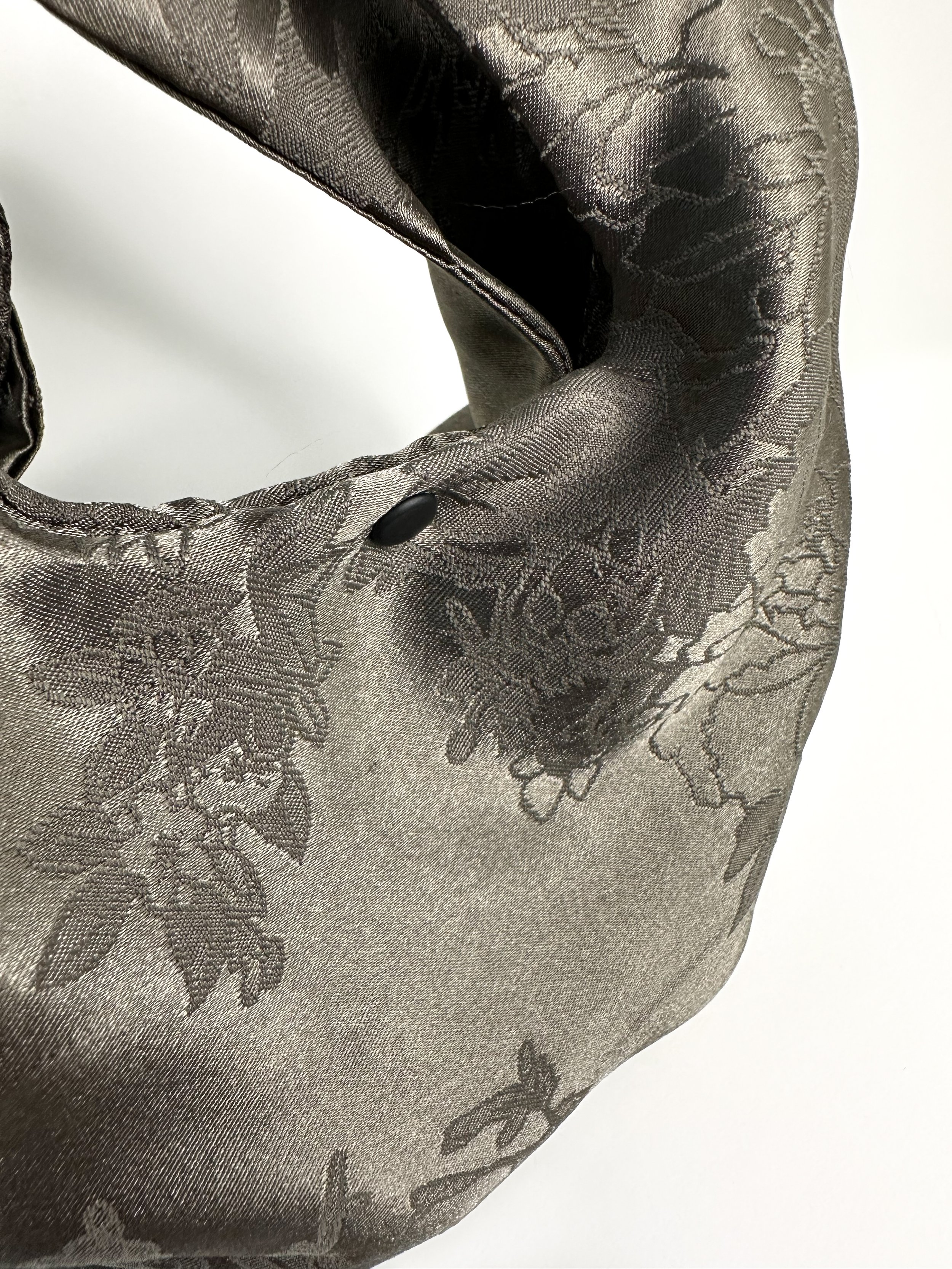 Detail shot of Dark warm gray floral damask fairy bag with black rivets hand sewn by Habit Flow