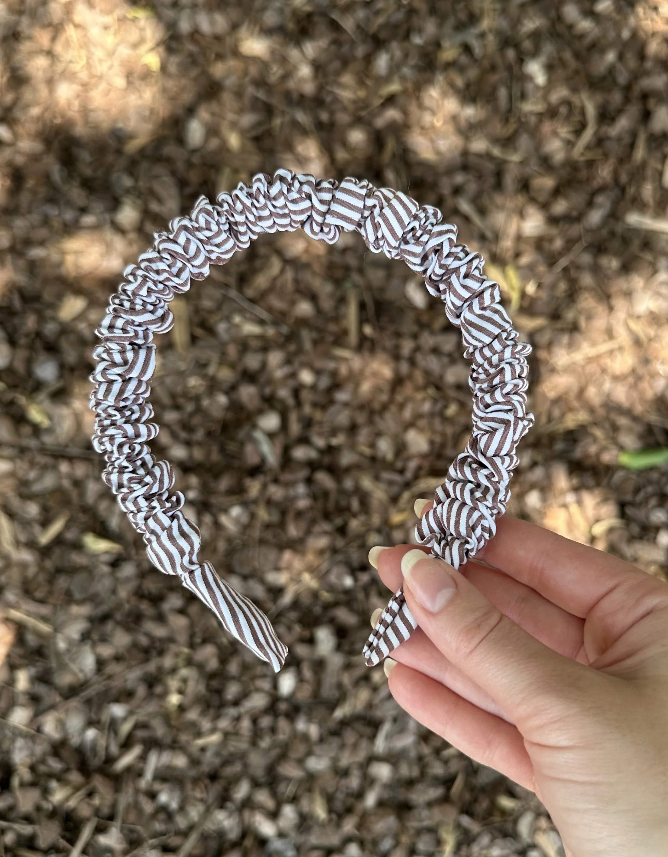 White and brown striped cotton headband with soft, earthy tones and a preppy edge