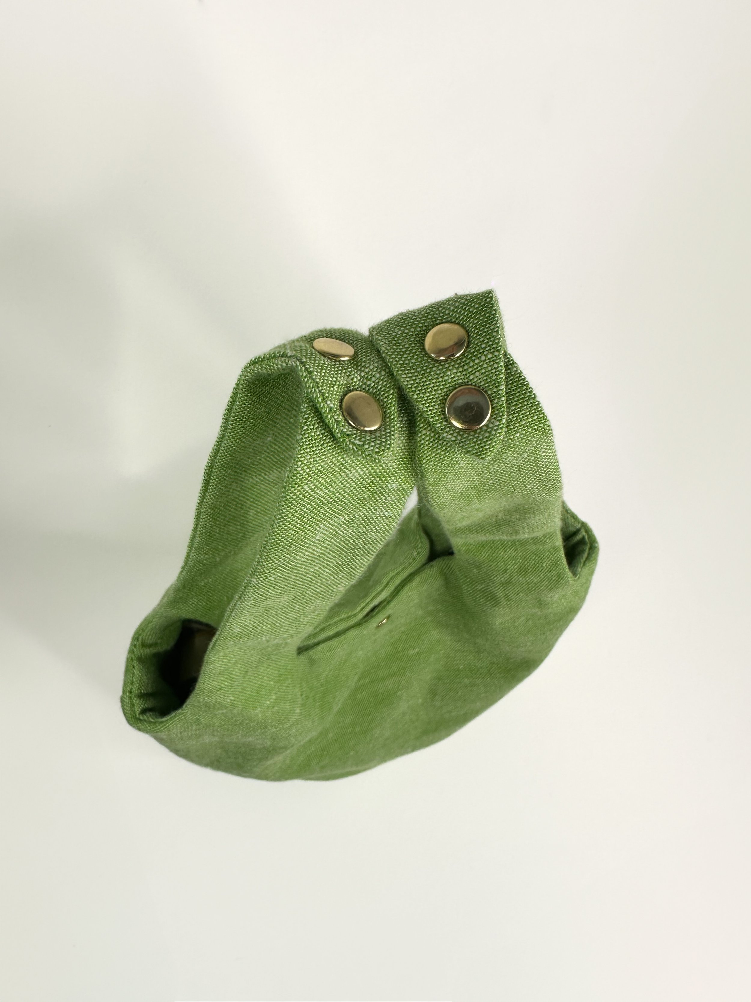 Top view of Grass green linen fairy bag with gold rivets hand sewn by Habit Flow