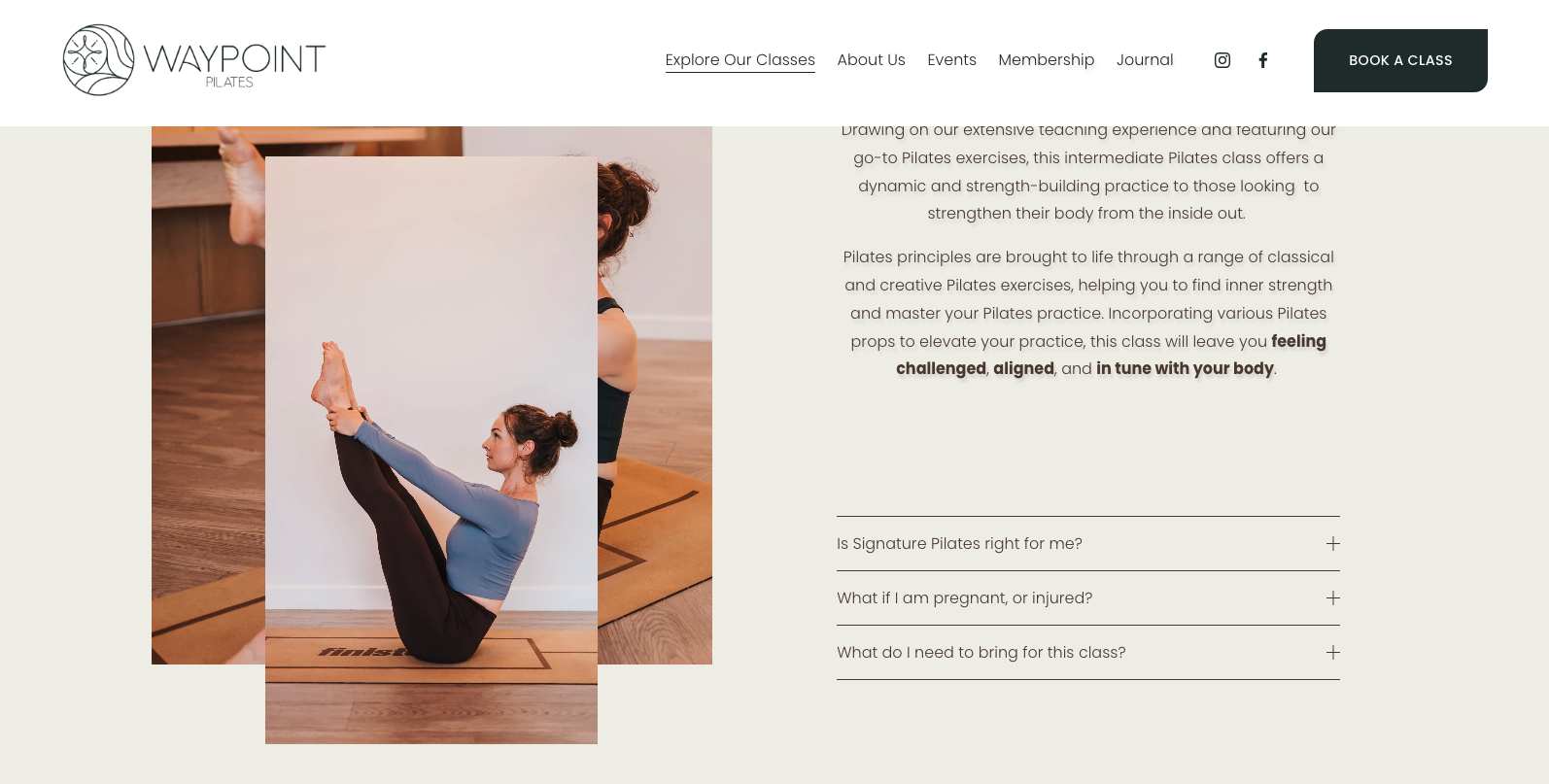 Woman in a light blue long-sleeve top and dark pants performing a Pilates pose with legs raised and grasped, in a studio with wooden floors and a white wall.