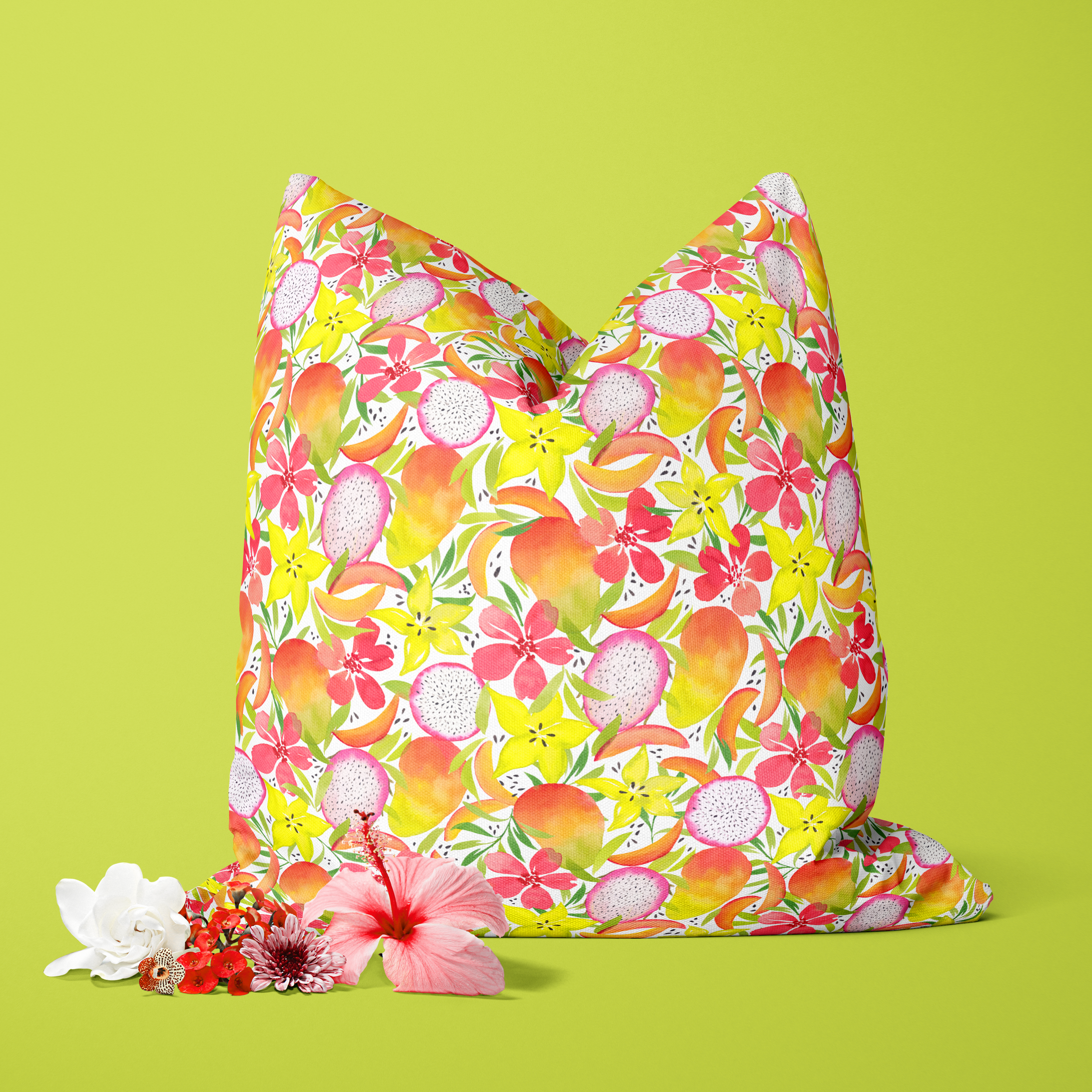 Colorful floral patterned pillow with tropical flower arrangements in front on lime green background.