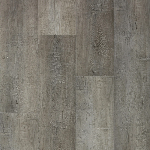 Close-up of Chisolm Trail Luxury Vinyl Tile by Jackson Vinyl, showcasing a wood appearance with a blend of gray hues from the Solution Core Origins Series.
