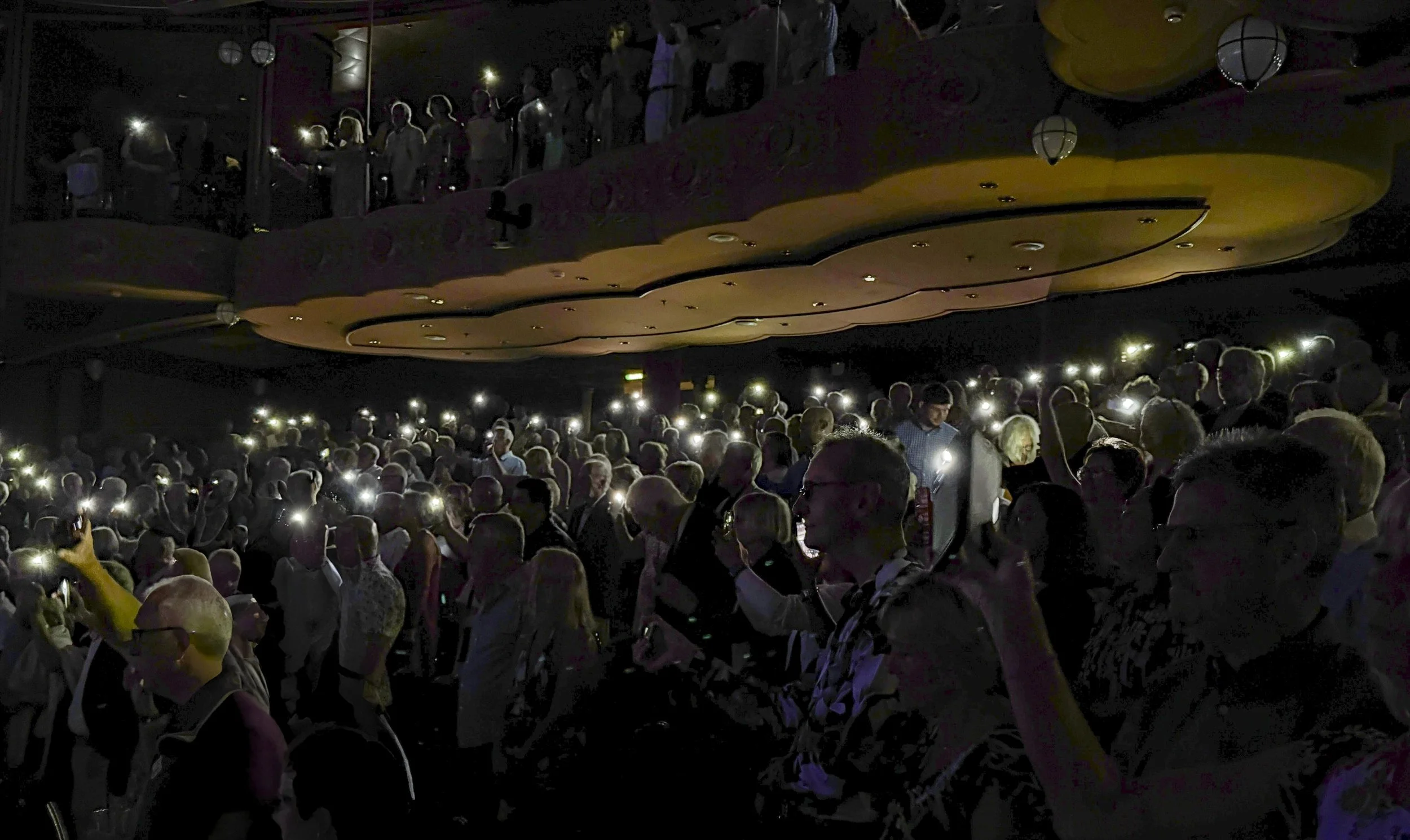 Phone Lights at the Evening Show on the Ship