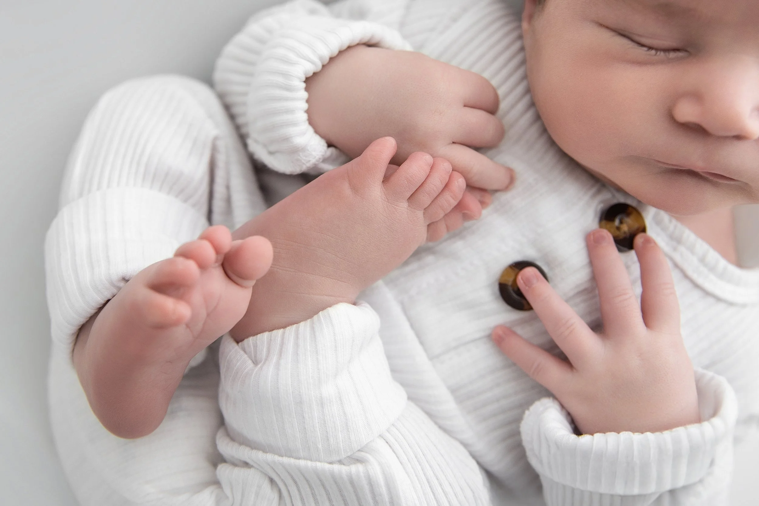 Close-up detail of newborn baby feet and hands during studio session | Rochester Hills newborn photographer | El & Em Photography