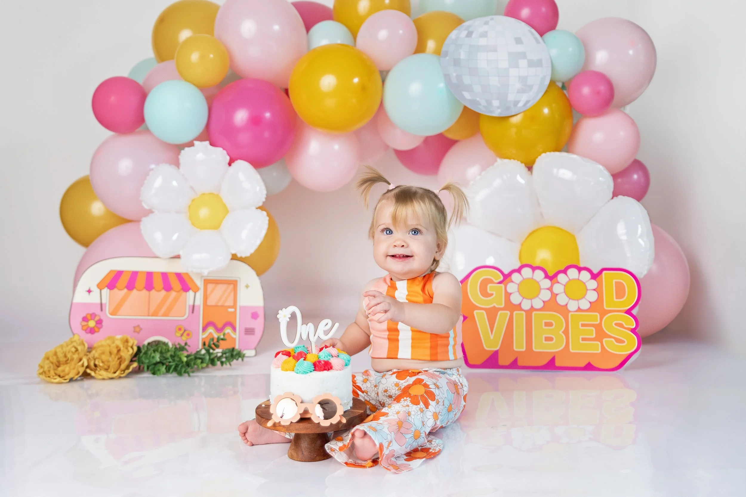 Baby enjoying cake during a first birthday cake smash photography session in Rochester Hills