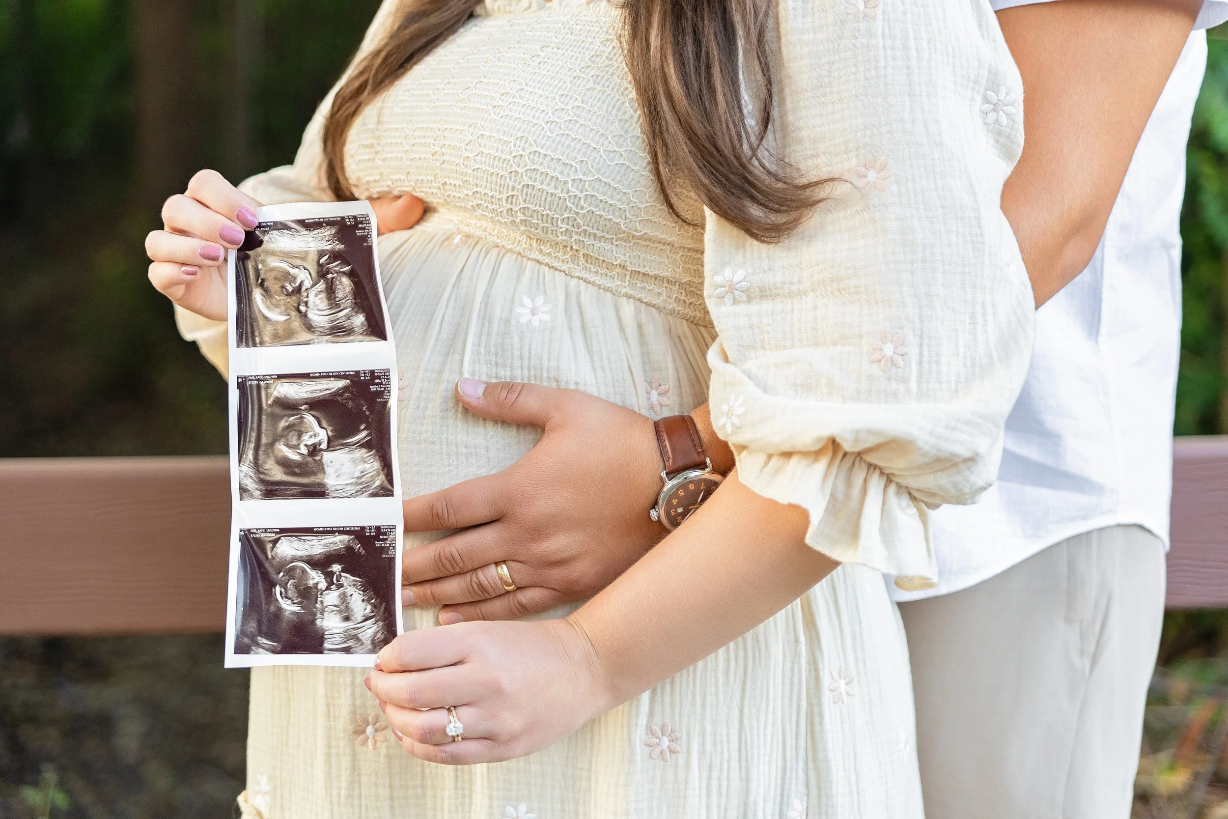 Expecting couple holding ultrasound photos during maternity session photographed by Rochester Hills maternity photographer El & Em Photography