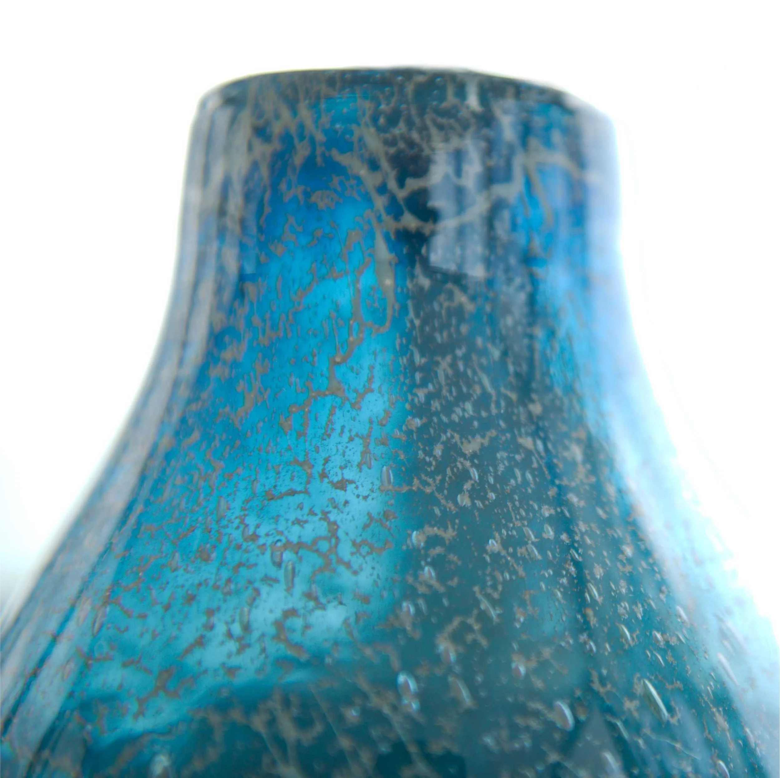 Close-up of a blue, textured, glass  vase