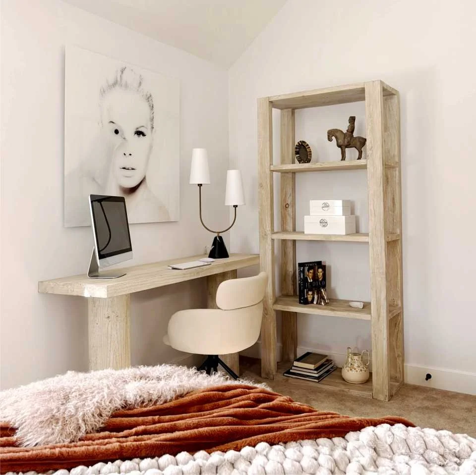 glass photo of lady with dove sits above a wood console desk.  A shelving unit is next to it with various decorations reflecting the stylish interior