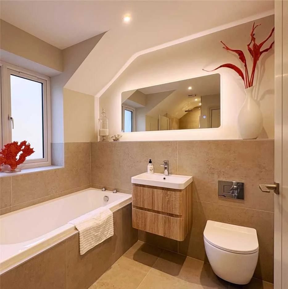 A simple modern bathroom with beige tiles and a floating wood panel sink.k. There are various accessories in white and carmine