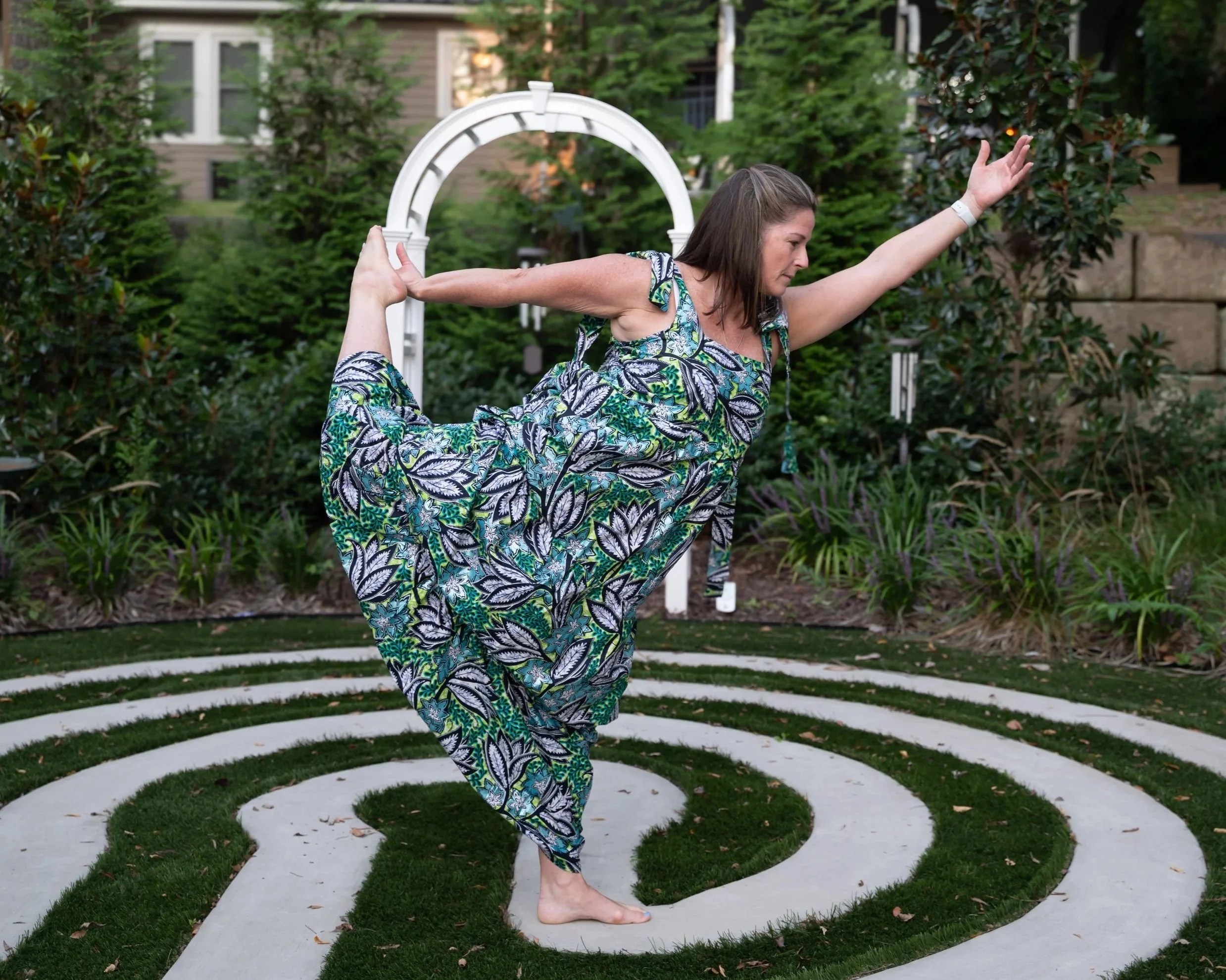 Rise Yoga student doing dancer pose in the garden.