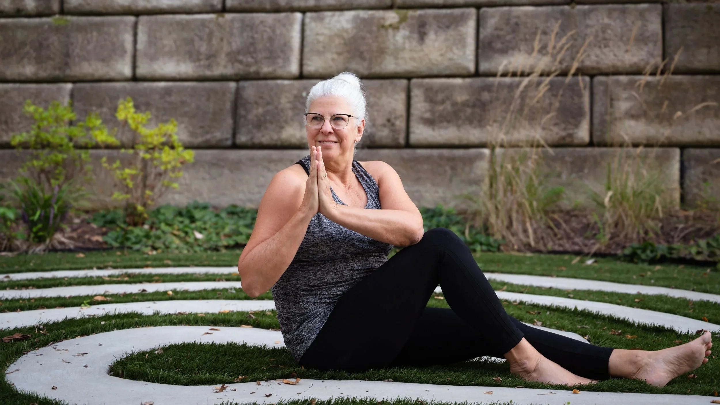 Rise Yoga student in a seated twist.