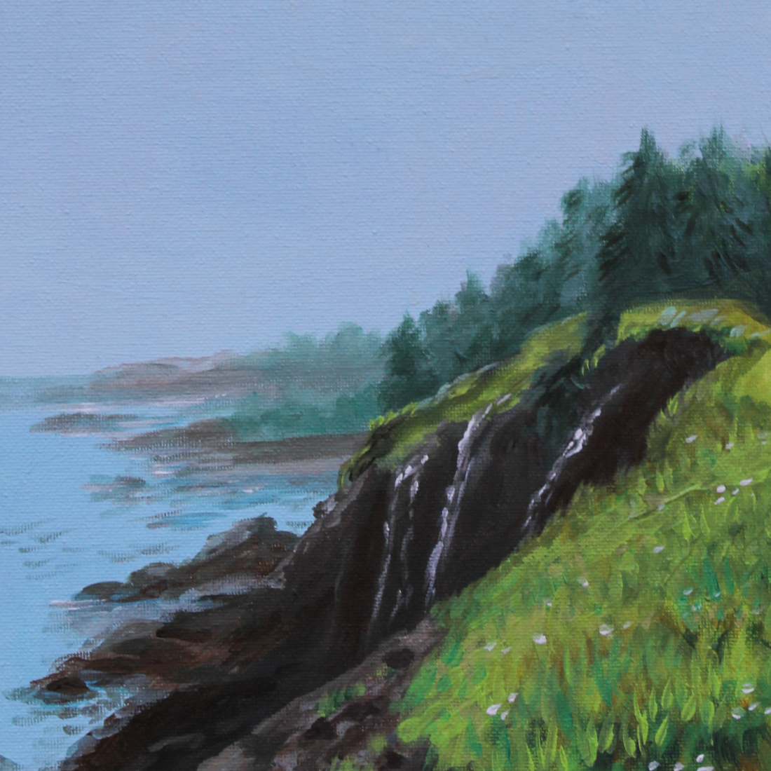 A landscape painting of a coastal scene with the ocean, a rocky shoreline, and green grassy hills topped with trees under a partly cloudy sky.