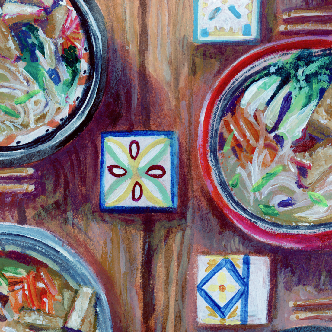 Painted bowls with an Asian-inspired soup on a wooden table, decorated with small colorful tiles.