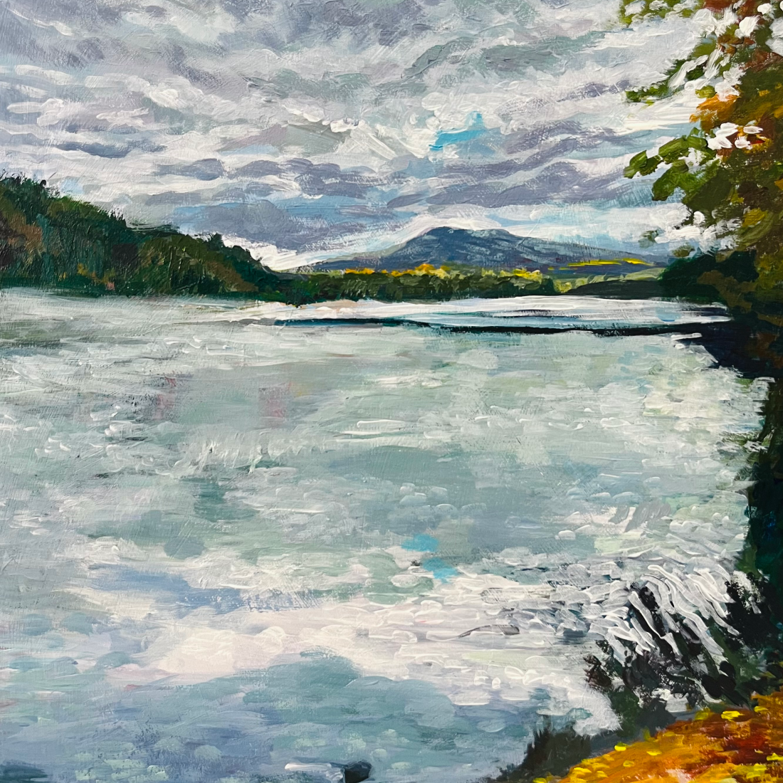 A colorful landscape painting of a lake with surrounded by fall trees and leaves, rolling mountains in the background, and a cloudy sky.