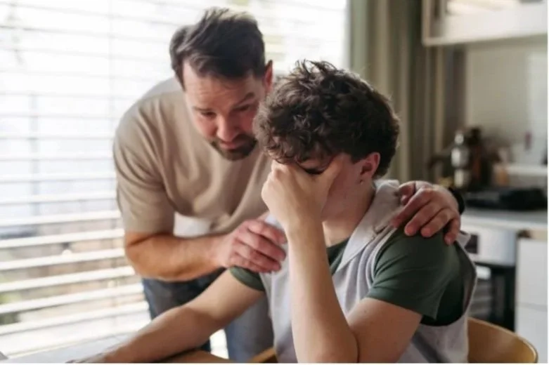 Father consoling son who is upset