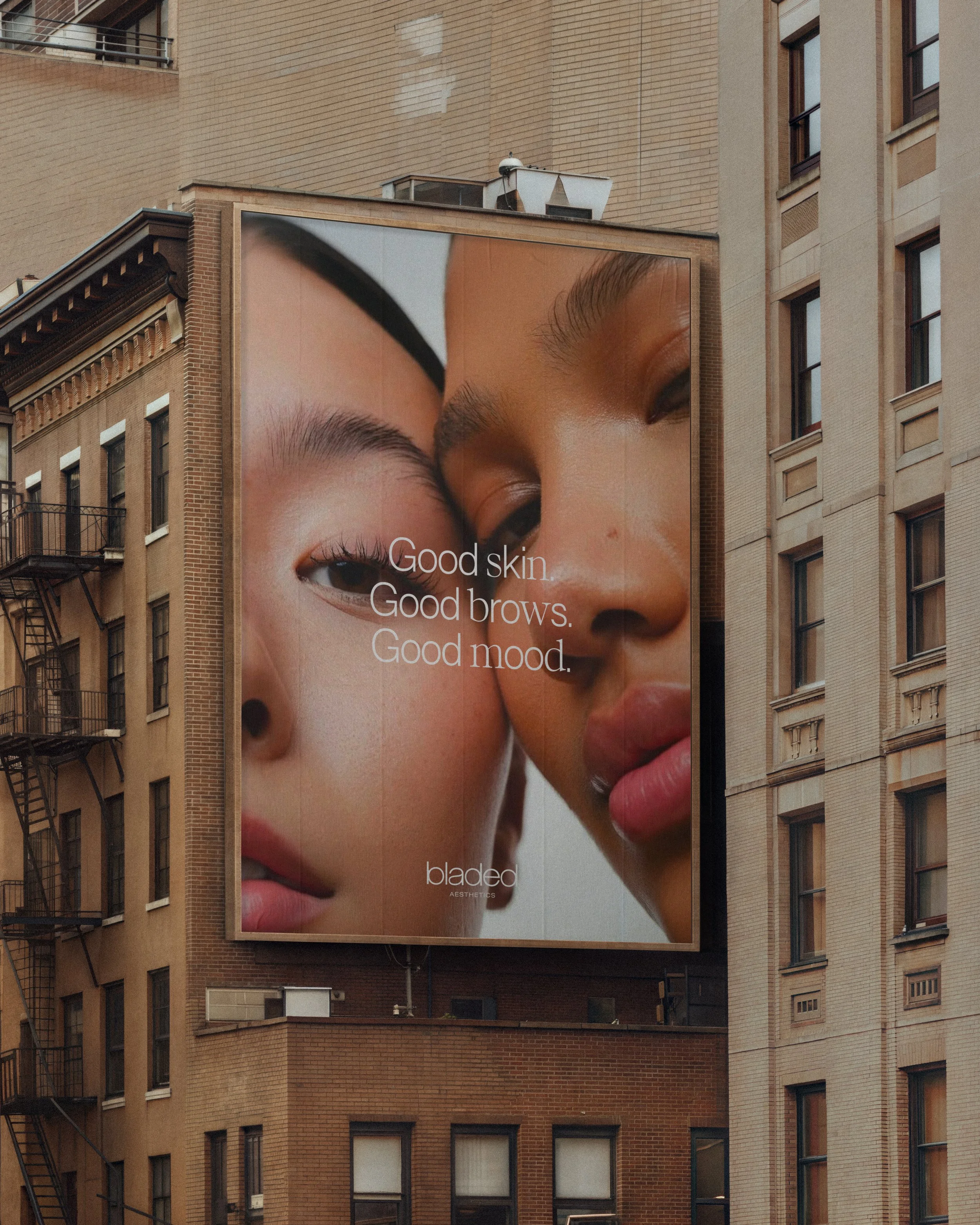 Three storefront signs displaying advertisements for Skin Theory skincare. The left and right signs show hands holding a bottle of cream, with the text "Skin Theory" and "aesthetics + wellness." The middle sign has a simple logo and the text "skin, simplified."